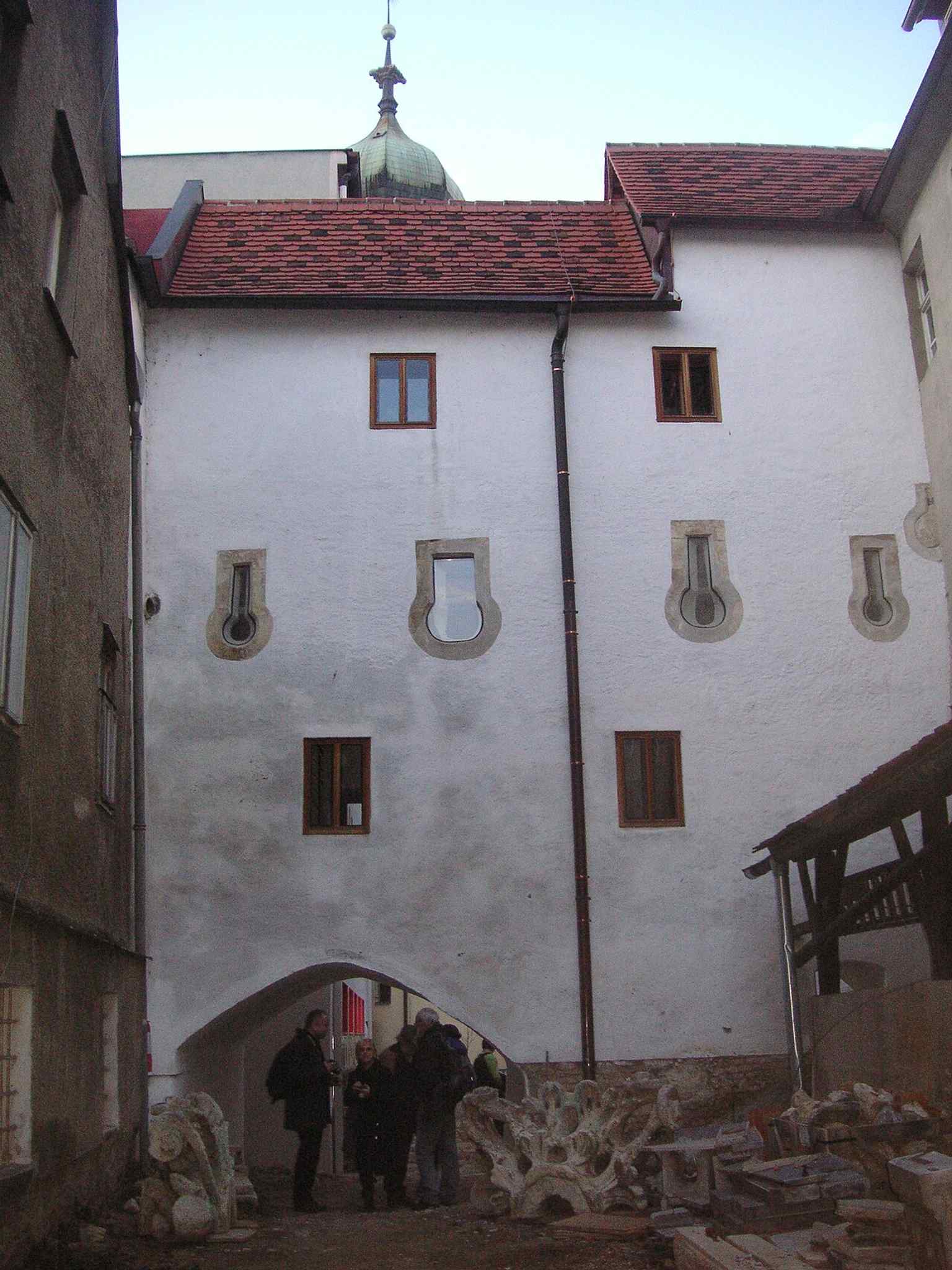 The former defensive tower at the rear of the complex reflects the 17th-century fortification role of the monastery.