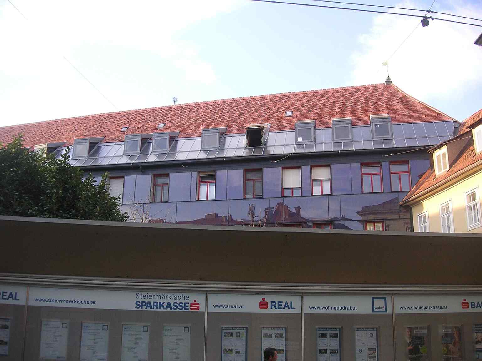 Modern solar panels on the long facade show the monastery’s recent technical upgrades, added without fully covering the old sundial.