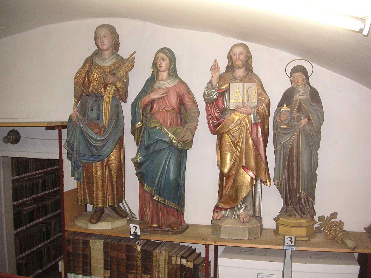 Statues in the library add a devotional layer to a room that safeguards thousands of rare theological and historical volumes.