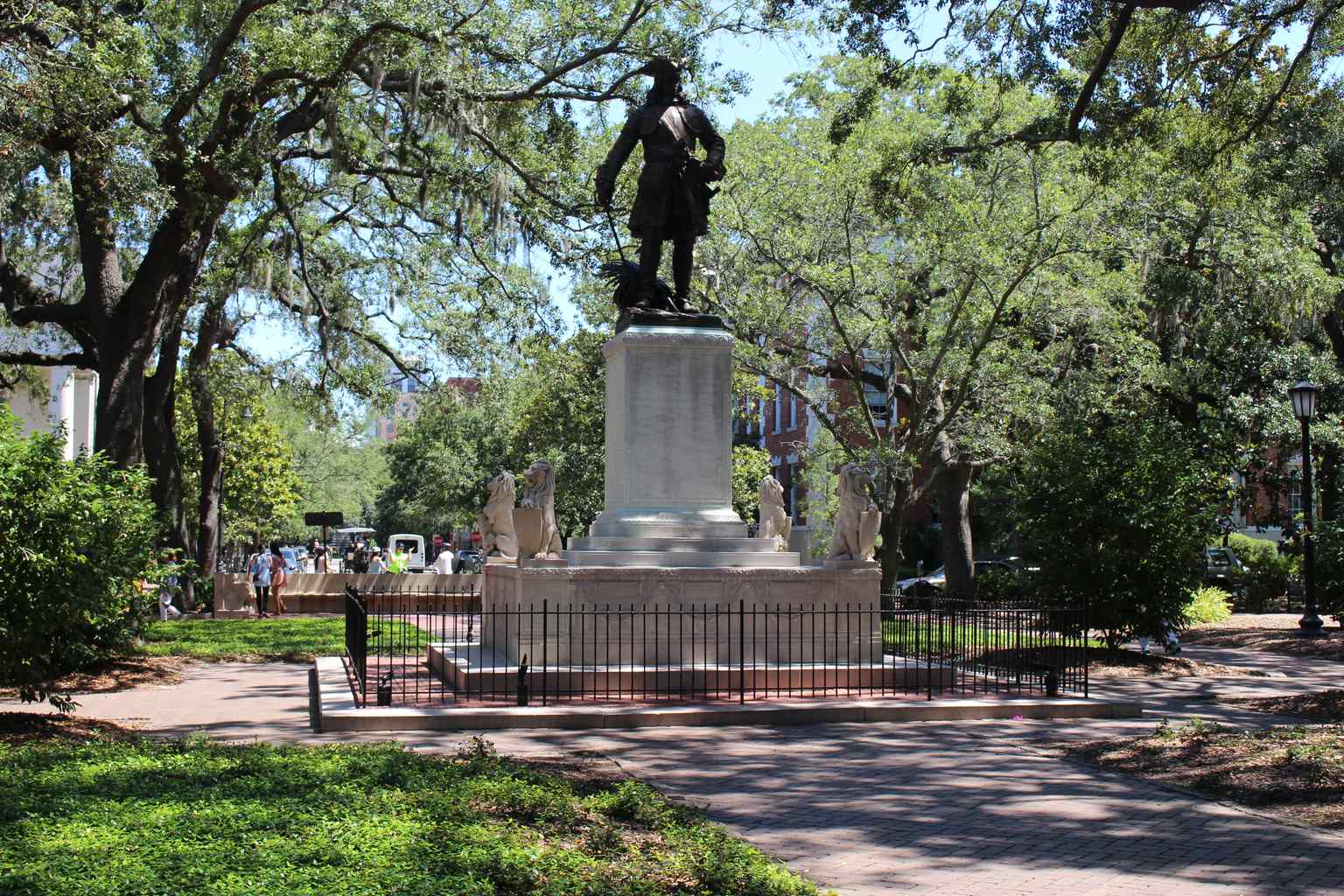 A detailed shot of James Oglethorpe's 9-foot bronze statue, depicting him in 18th-century military uniform with a sword, deliberately posed facing south to symbolize the threat from Spain.