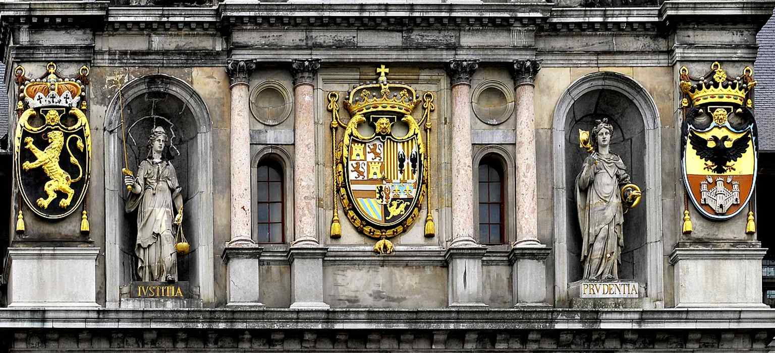 A close look at the façade details reveals the carved coats of arms and classical ornament that reflect Flemish and Italian Renaissance influence.