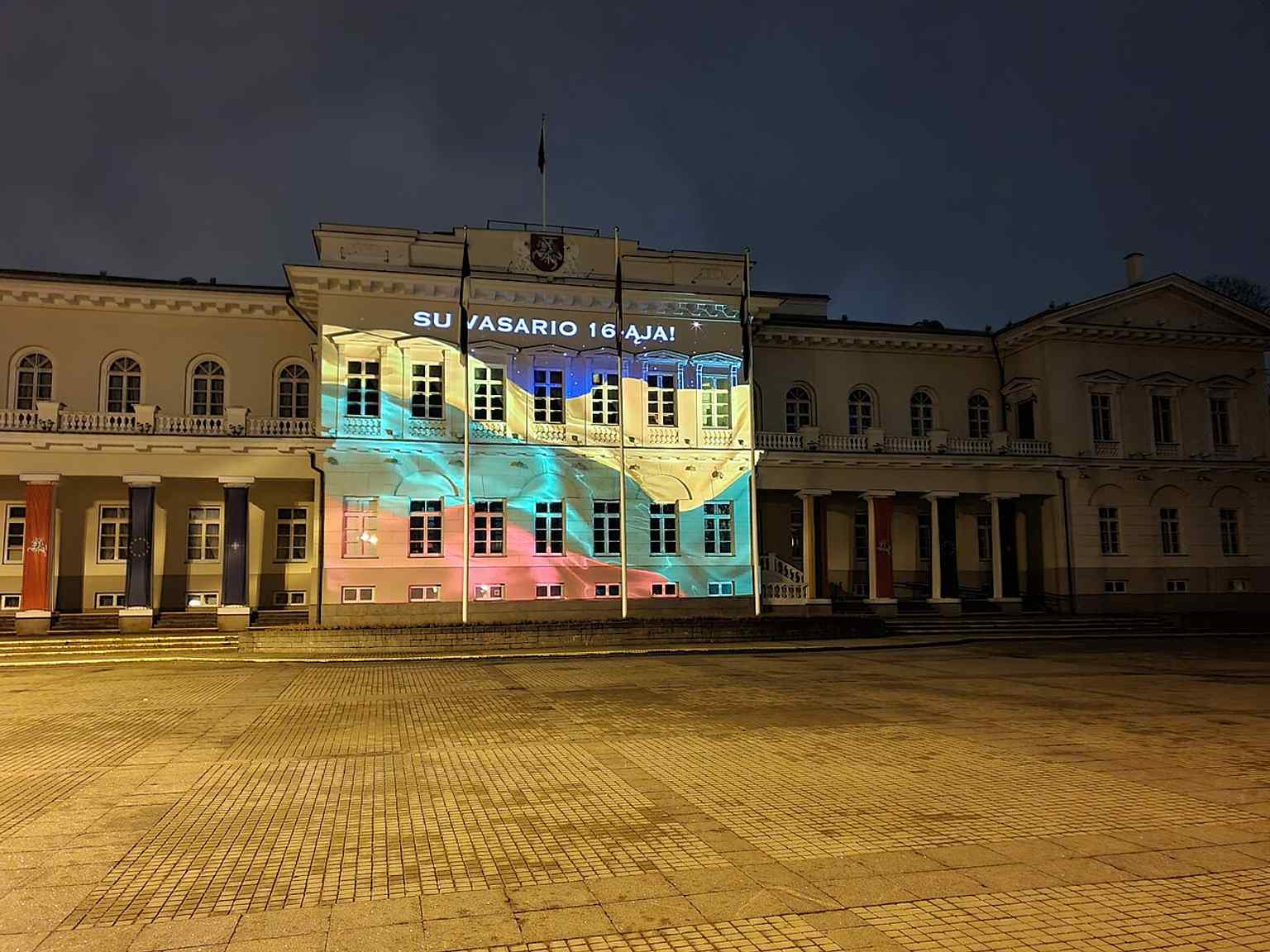 Flags and the festive frontage highlight the palace as Lithuania’s official presidential workplace, especially on national celebration days.