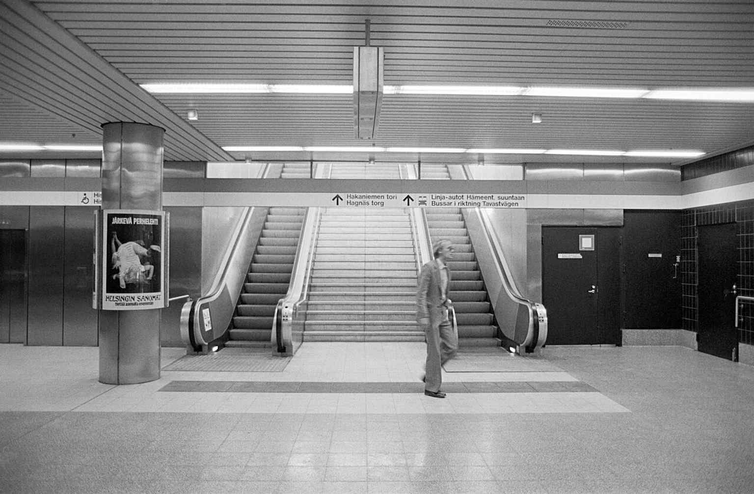 An exit from Hakaniemi metro station directly to Hakaniementori — a reminder that the square is built around transit.