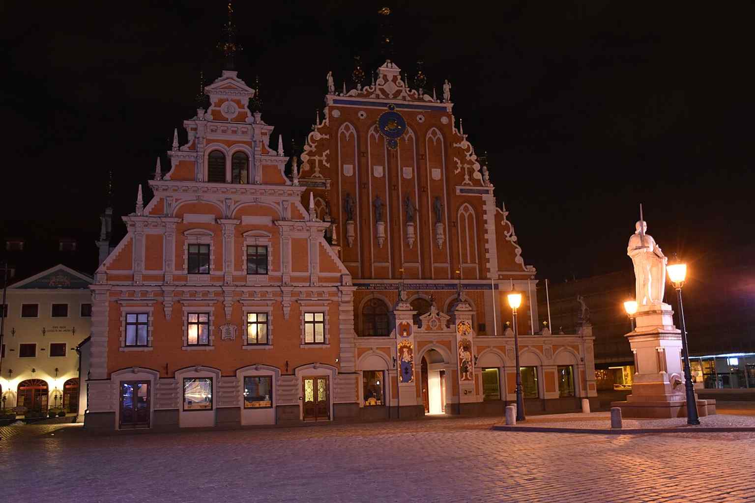 Night illumination brings out the façade’s sculptural details, echoing the building’s role as one of Riga’s most ceremonial and photographed monuments.