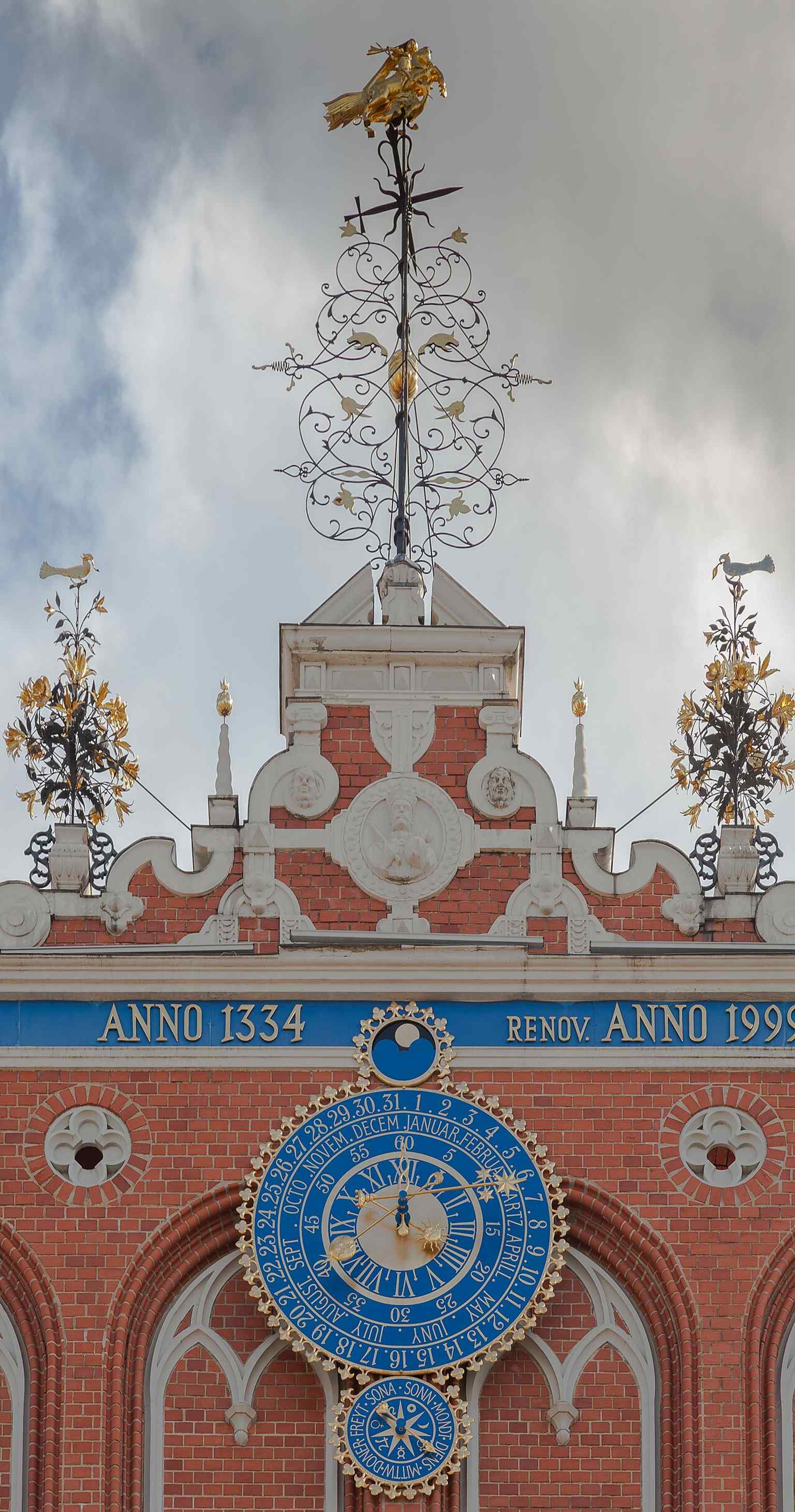 A tight view of the façade’s upper section, where the famous astronomical clock once displayed time, lunar phases, and zodiac signs.