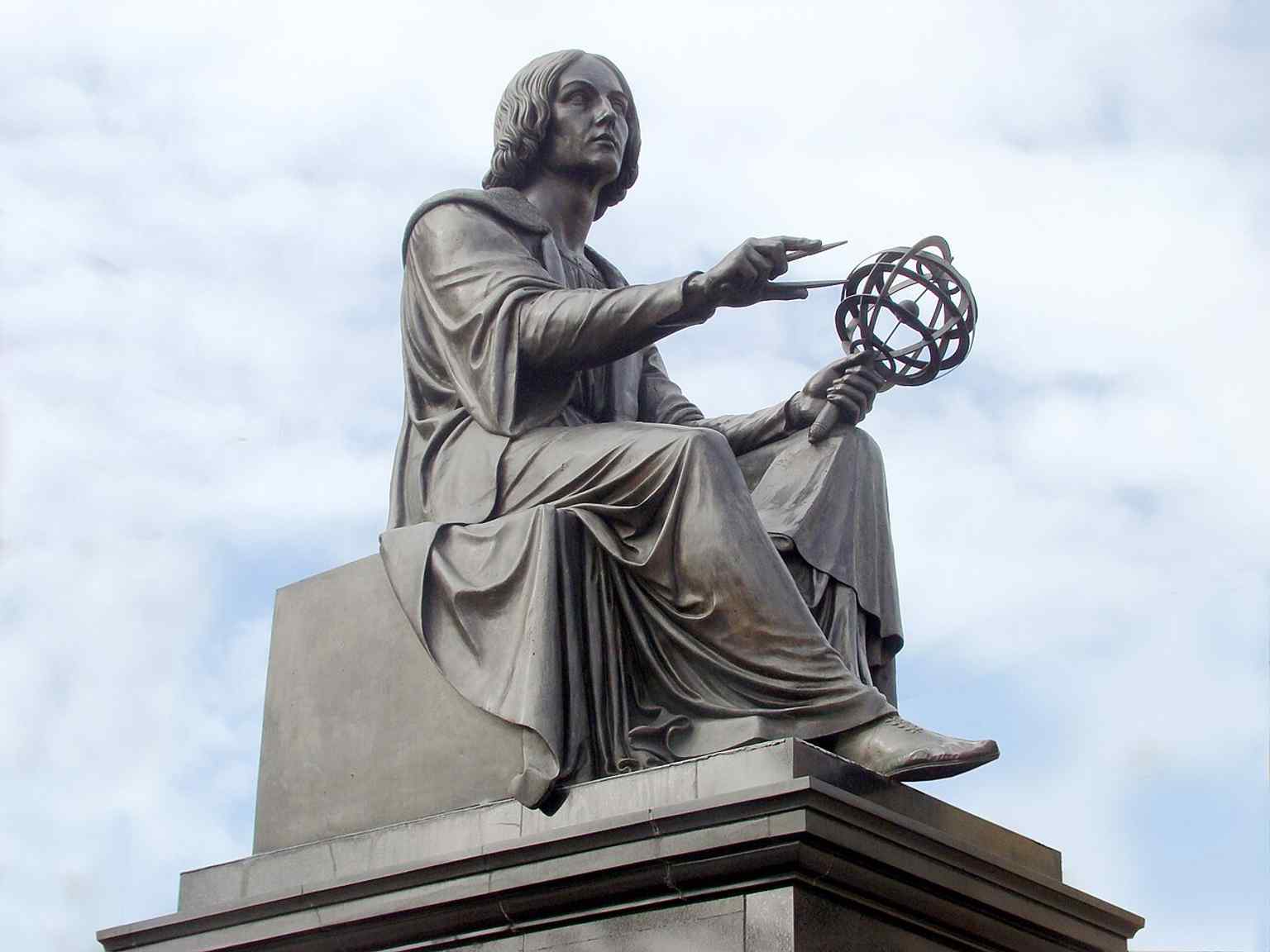 A closer look at Thorvaldsen’s seated Copernicus, emphasizing the compass in his right hand and the armillary sphere in his left.