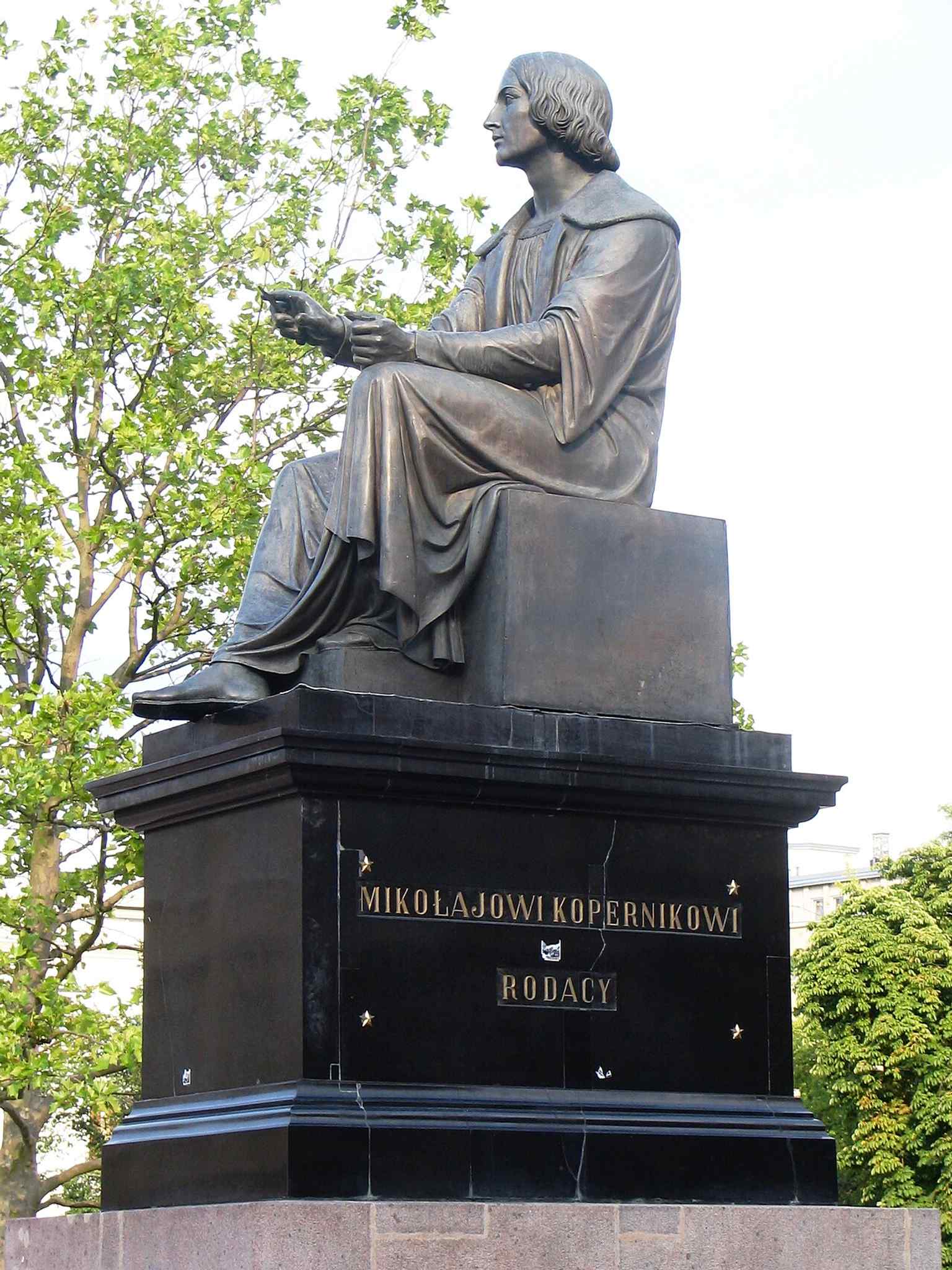 The monument shown without the armillary sphere, echoing the 2008 vandalism when the globe was torn from Copernicus’s hand.