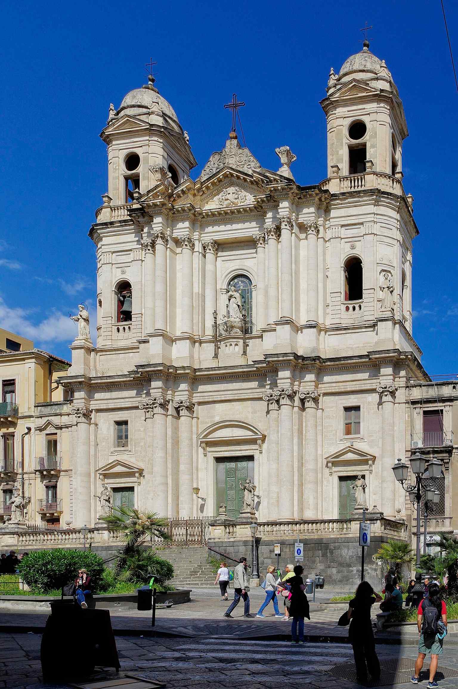A dramatic black-and-white exterior view that emphasizes the monumental façade and its twin towers over Piazza San Francesco.