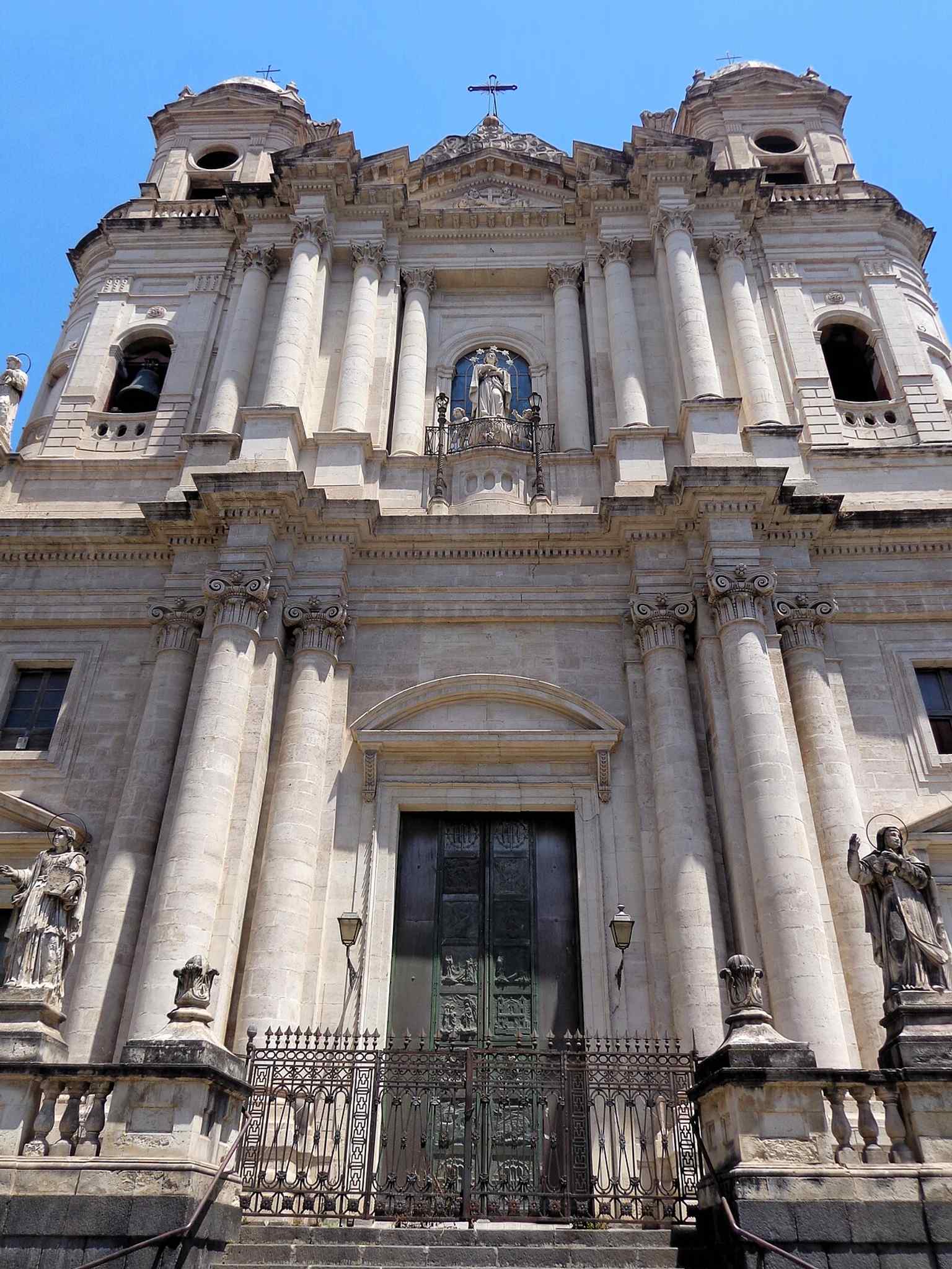 The side view of the church helps reveal the long basilica body behind the ornate front, reflecting the layered rebuilds over centuries.