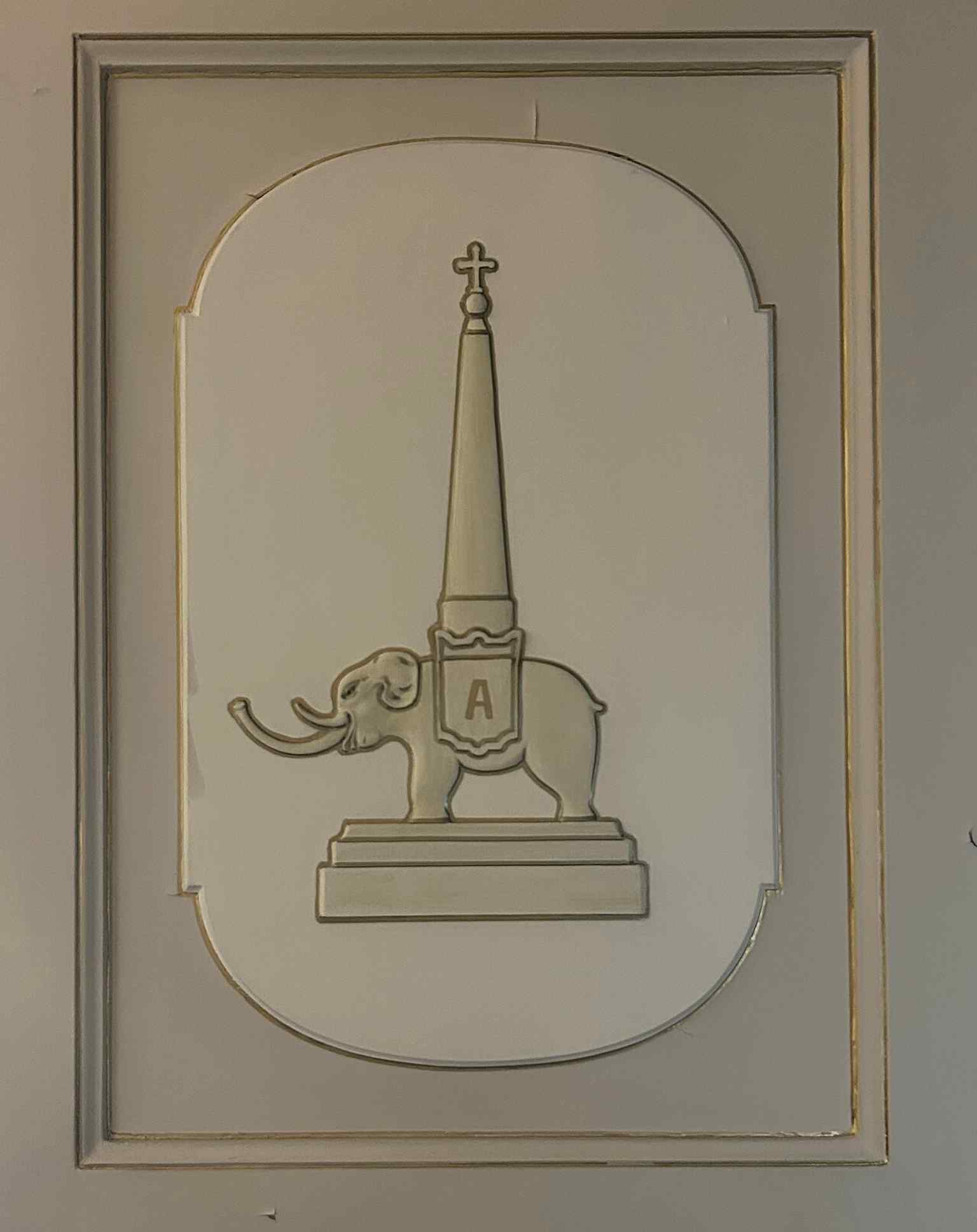 A carved elephant motif on a wooden door, a subtle reminder of the symbol that defines the palace’s identity.