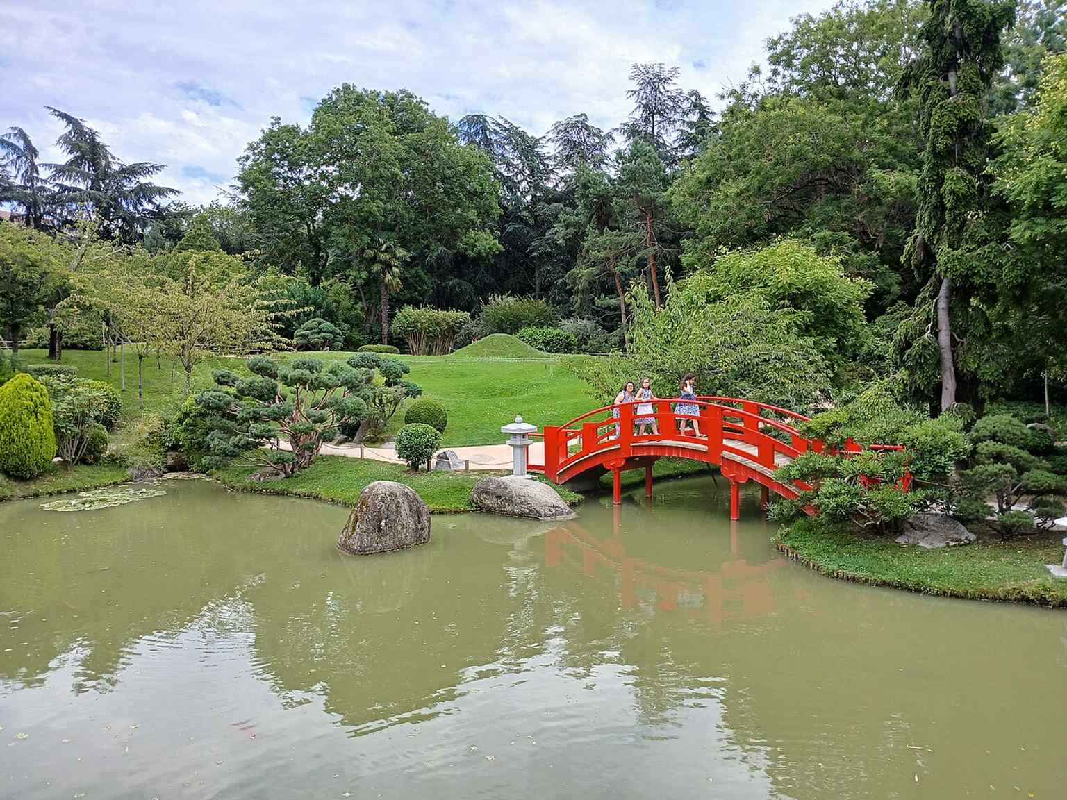 A wide exterior view of the garden’s pathways and greenery, capturing the peaceful setting now occupying the old Compans and Caffarelli barracks area.