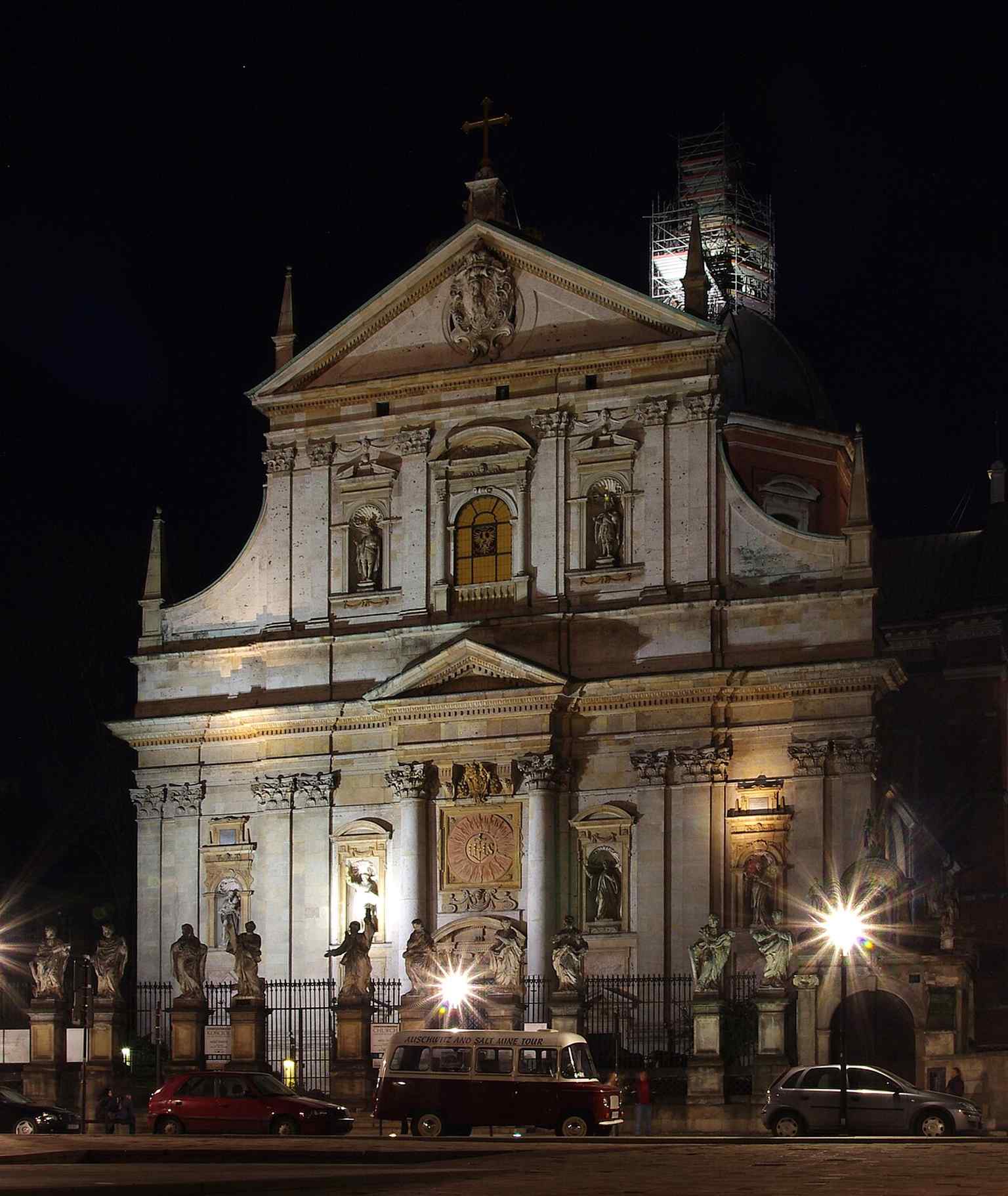 Night-time exterior of the church, showing how the monumental façade stands out after dark in the Old Town streetscape.