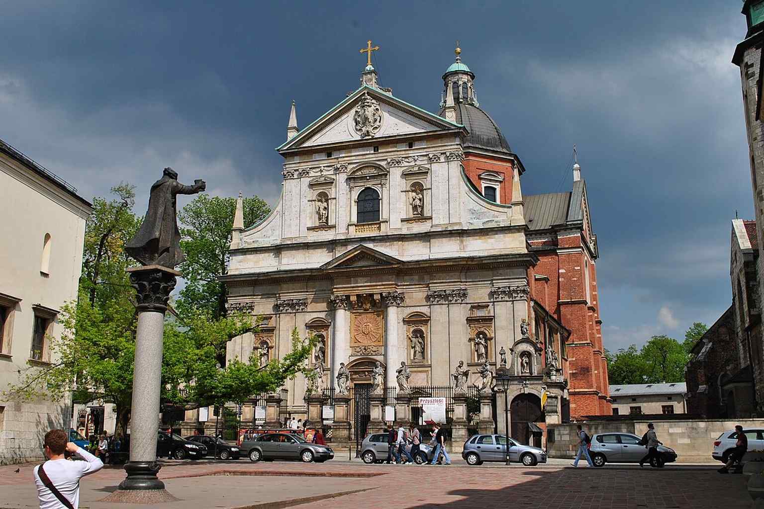 A wider exterior view from Grodzka Street that helps place the church in Kraków’s historic center, just below Wawel Hill.