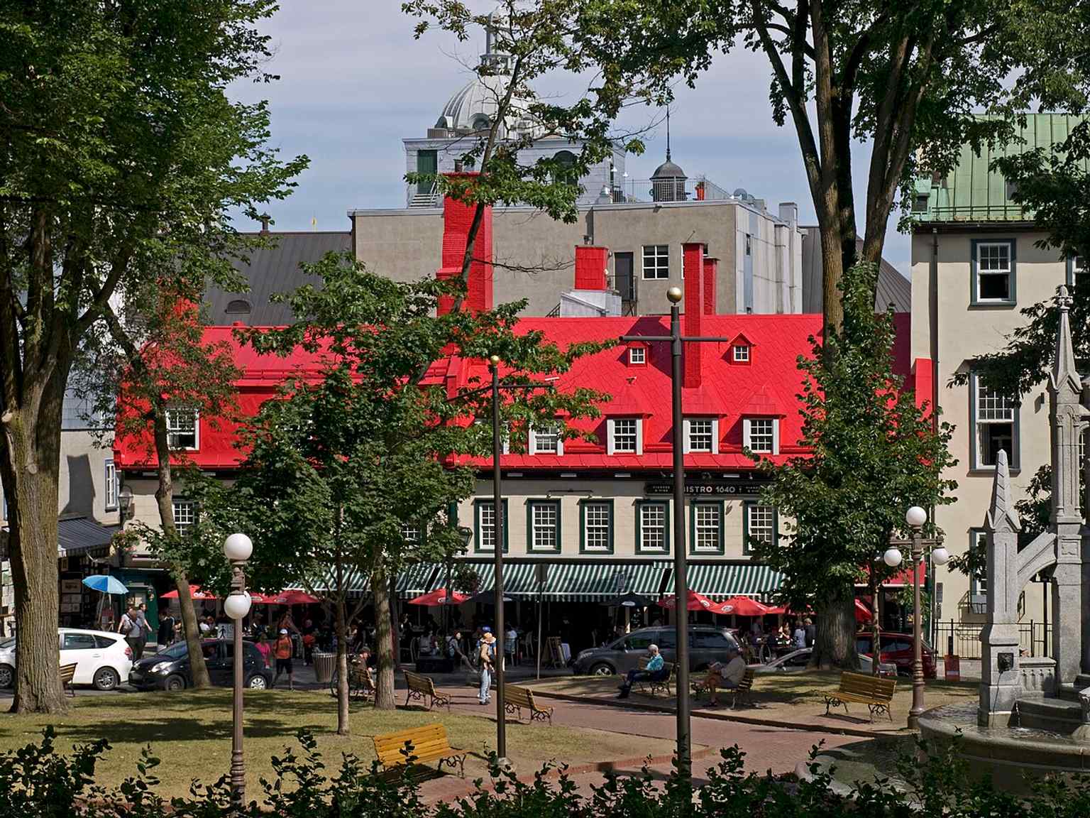 A street-level view of Place d’Armes by Rue Sainte-Anne, showing the square’s historic urban setting in the Upper Town of Old Quebec.