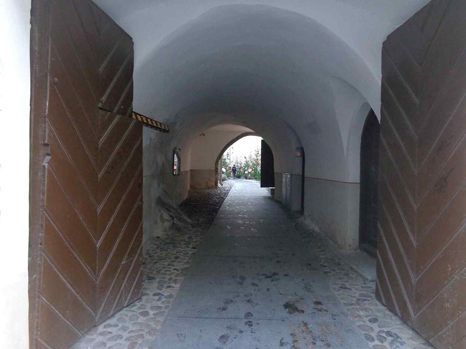 The Lai Street entrance to Börsi käik shows how the guild complex opens toward the rear side of the block, beyond the main Pikk Street façade.