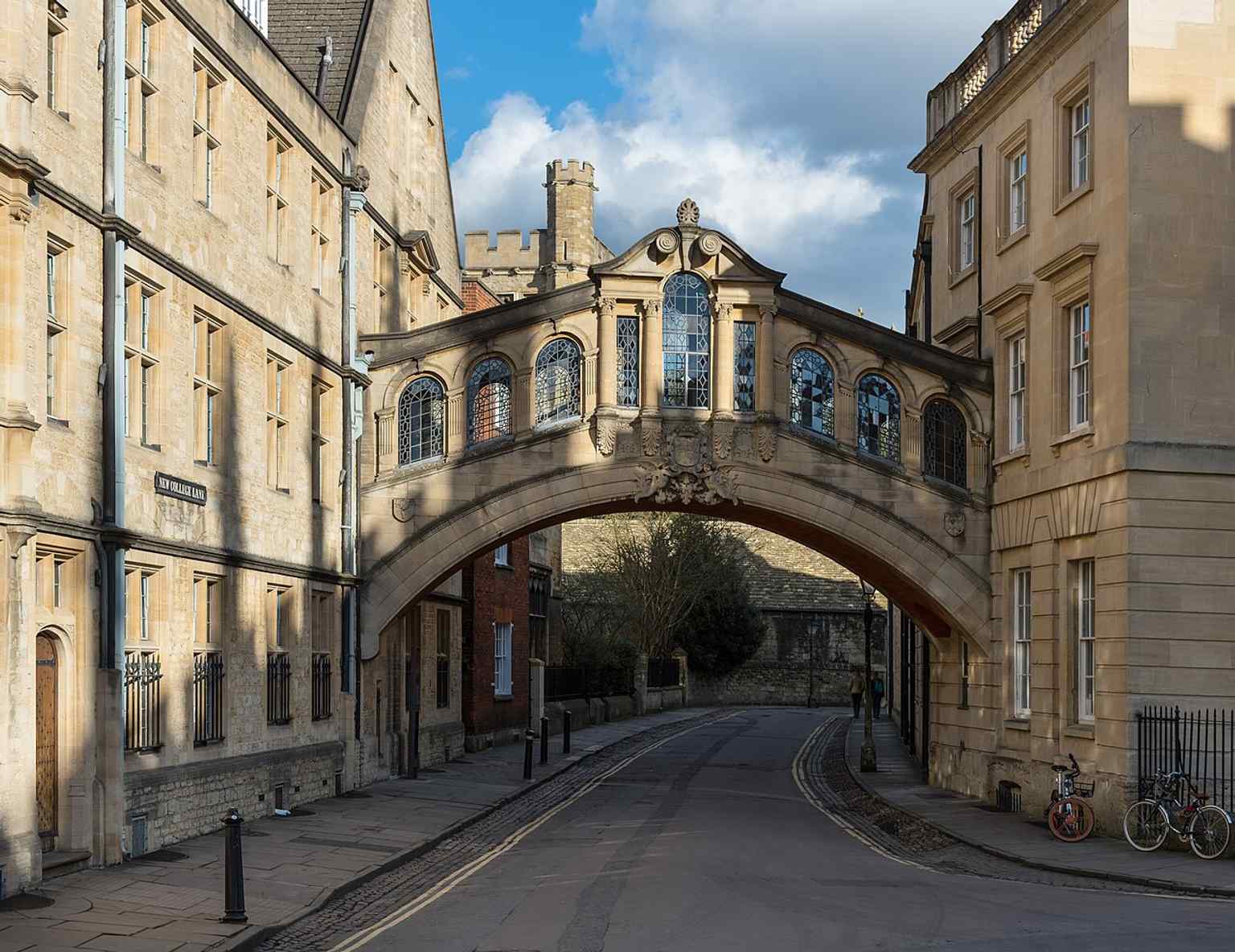 A dramatic west-facing view with shadow across the bridge, emphasizing its distinctive stonework and enclosed skyway form.