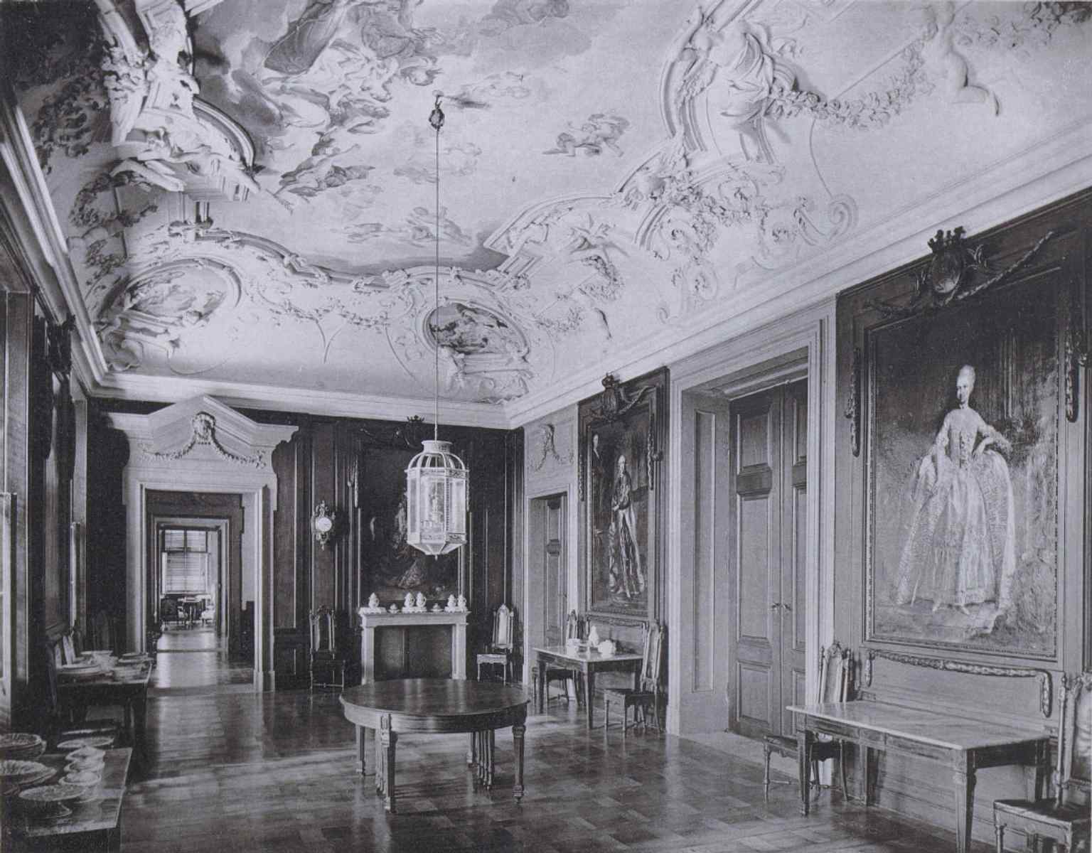 The 'Sál předků' (Ancestors' Hall) in an 1888 photo, originally a dining room, featuring monumental frescoes and portraits of prominent Kounic family members.