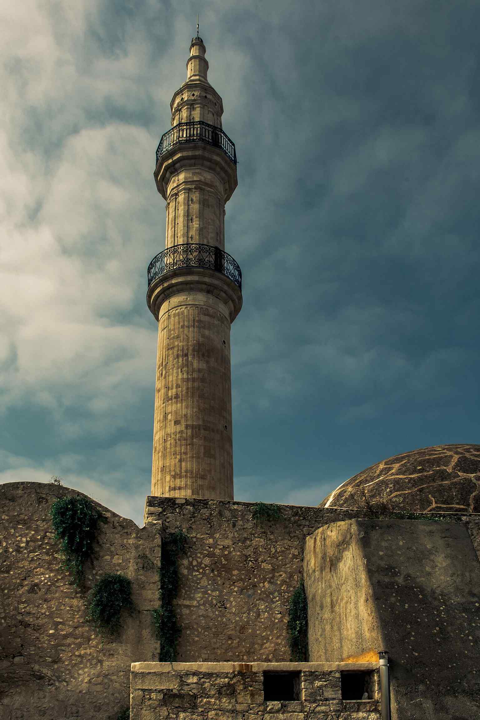 A vertical shot emphasizing the minaret's elegant structure and its two distinct balconies from a different perspective.