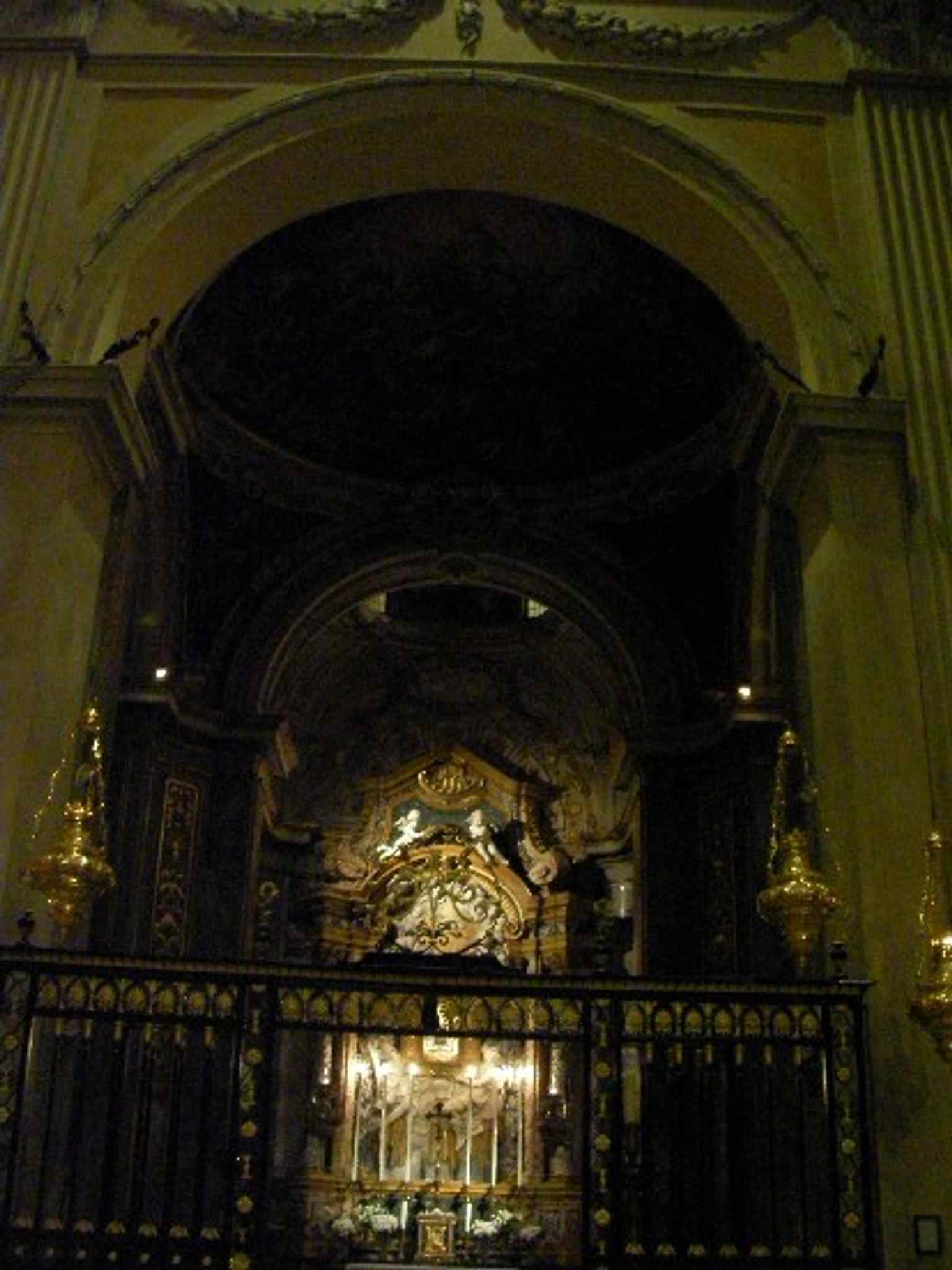 A vertical interior view of the left chapel, showing the scale and layered decoration of the nave-side chapels.