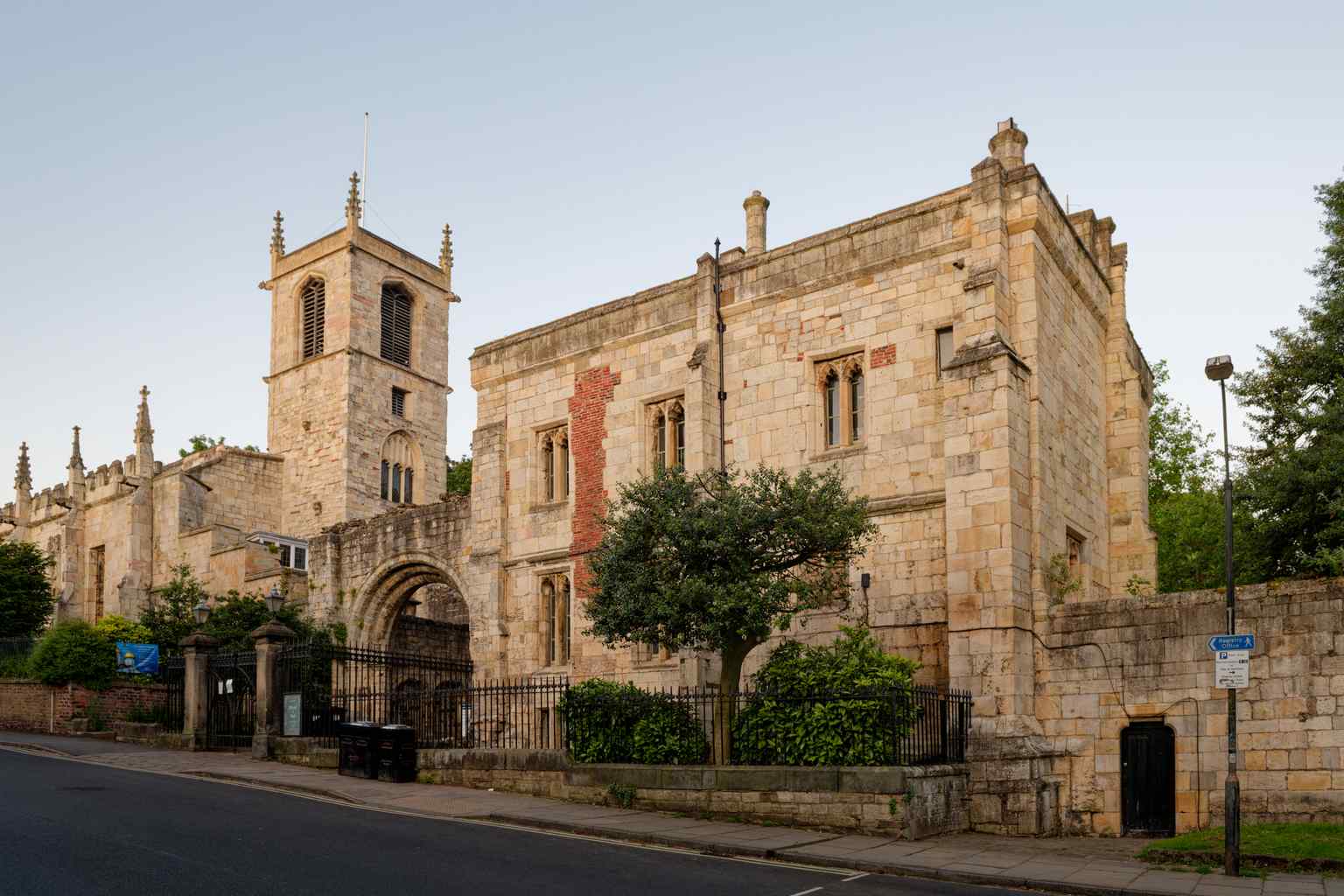 The rugged exterior stonework of Saint Olave's on Marygate, which stands amidst the jagged, ruined walls of the neighboring Saint Mary's Abbey (2024).