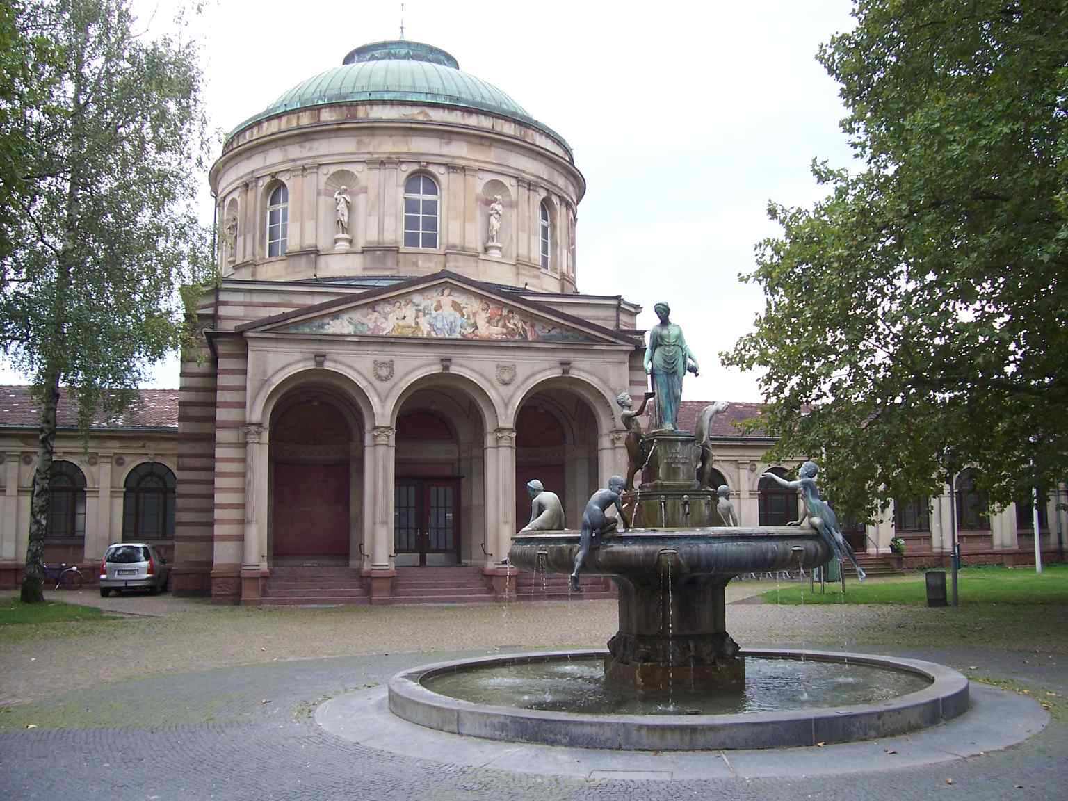 The Hygieia Fountain stands prominently before the Vierordtbad, a location Wilhelm Klose insisted upon despite city resistance.