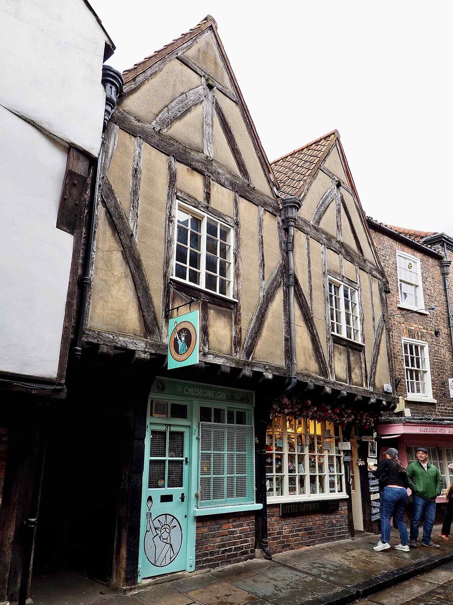 A closer view that helps pick out the timber-framed upper storey, echoing the surviving medieval fabric and later rebuilding noted in heritage records.