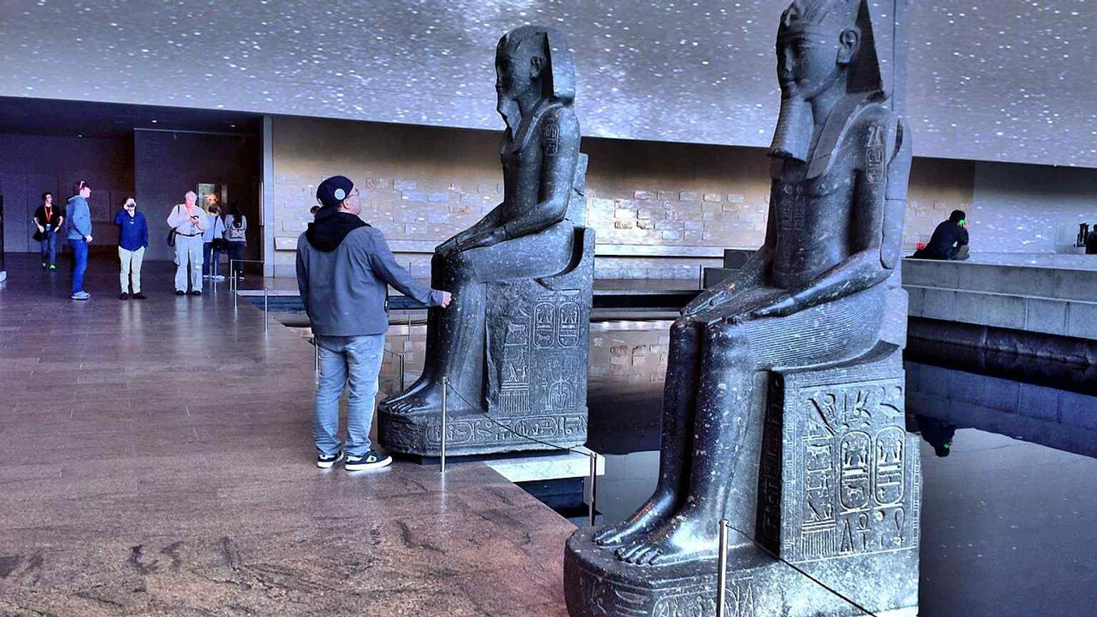 The statues of Amenhotep III at the Met, part of the Egyptian display world that surrounds the Temple of Dendur in this wing.
