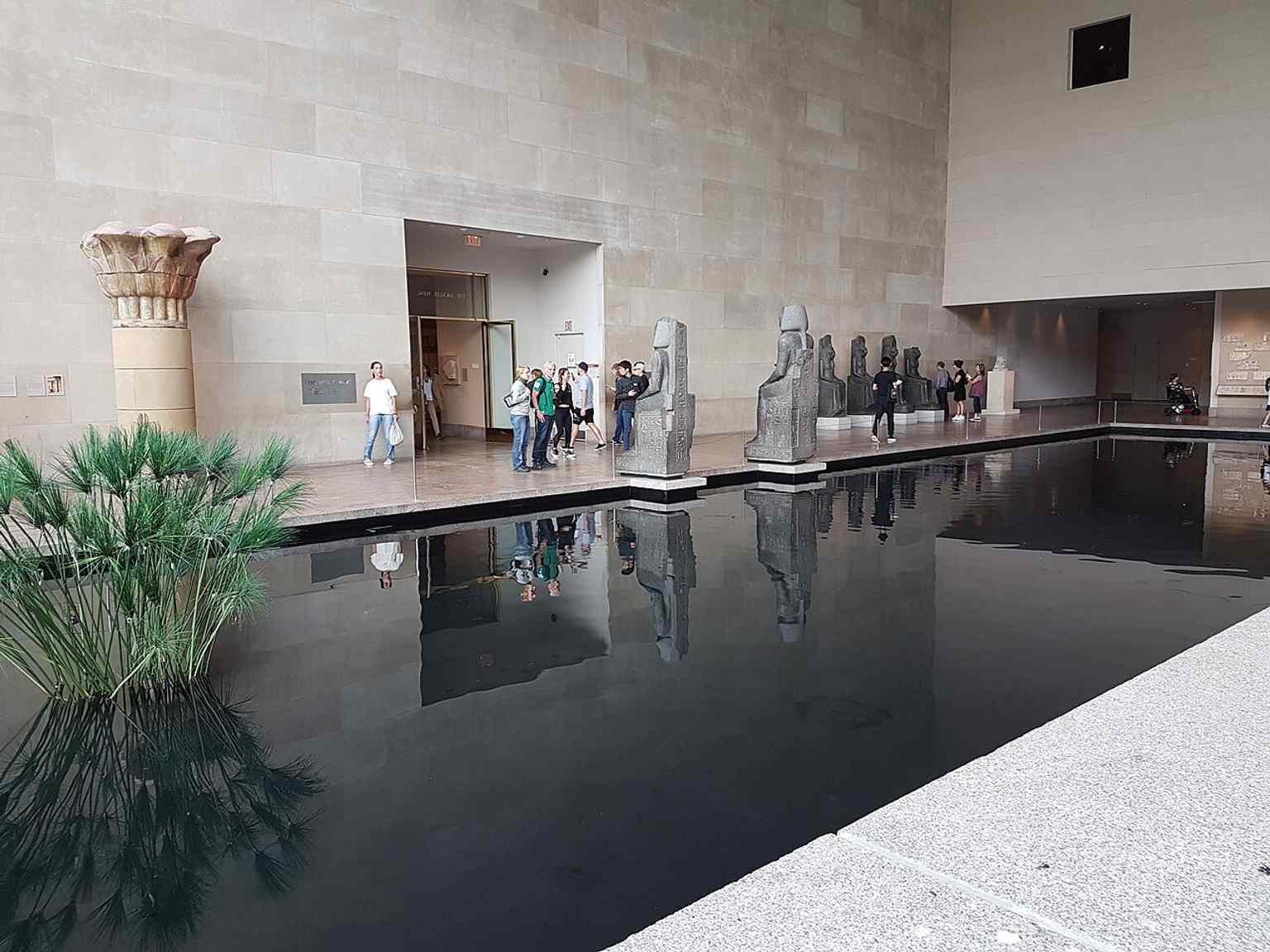 The calm reflecting pool and stone setting that turned the wing into a carefully staged interior landscape for the temple.