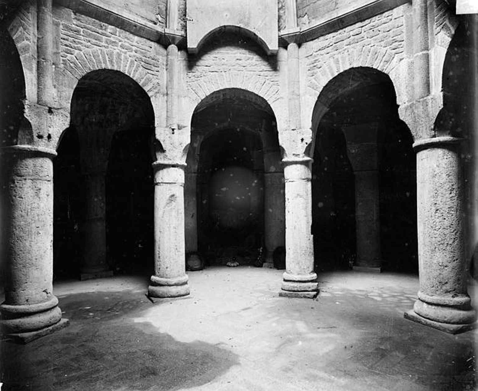 The arcades of the crypt, demonstrating the architectural style of the lower level of the original rotonda, which was rediscovered and restored in the 19th century by Jean-Philippe Suisse.