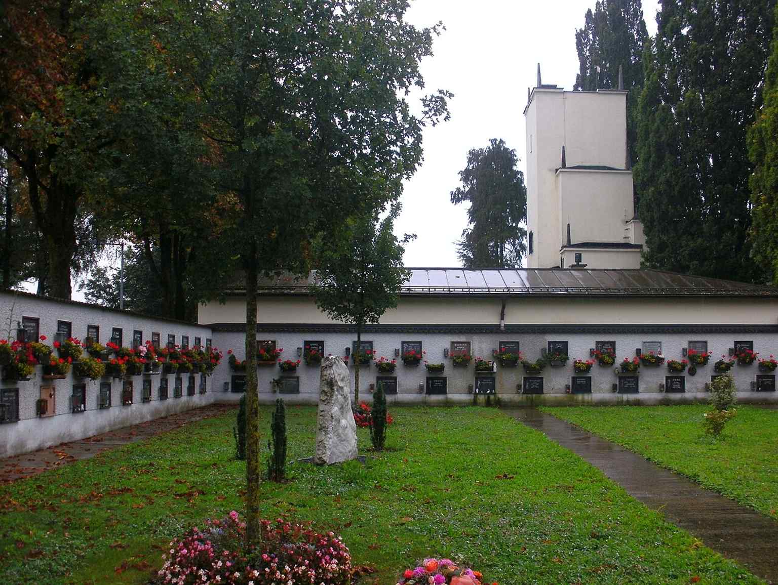 A broader view of the crematorium and urn cemetery together, showing the memorial landscape around the main building.