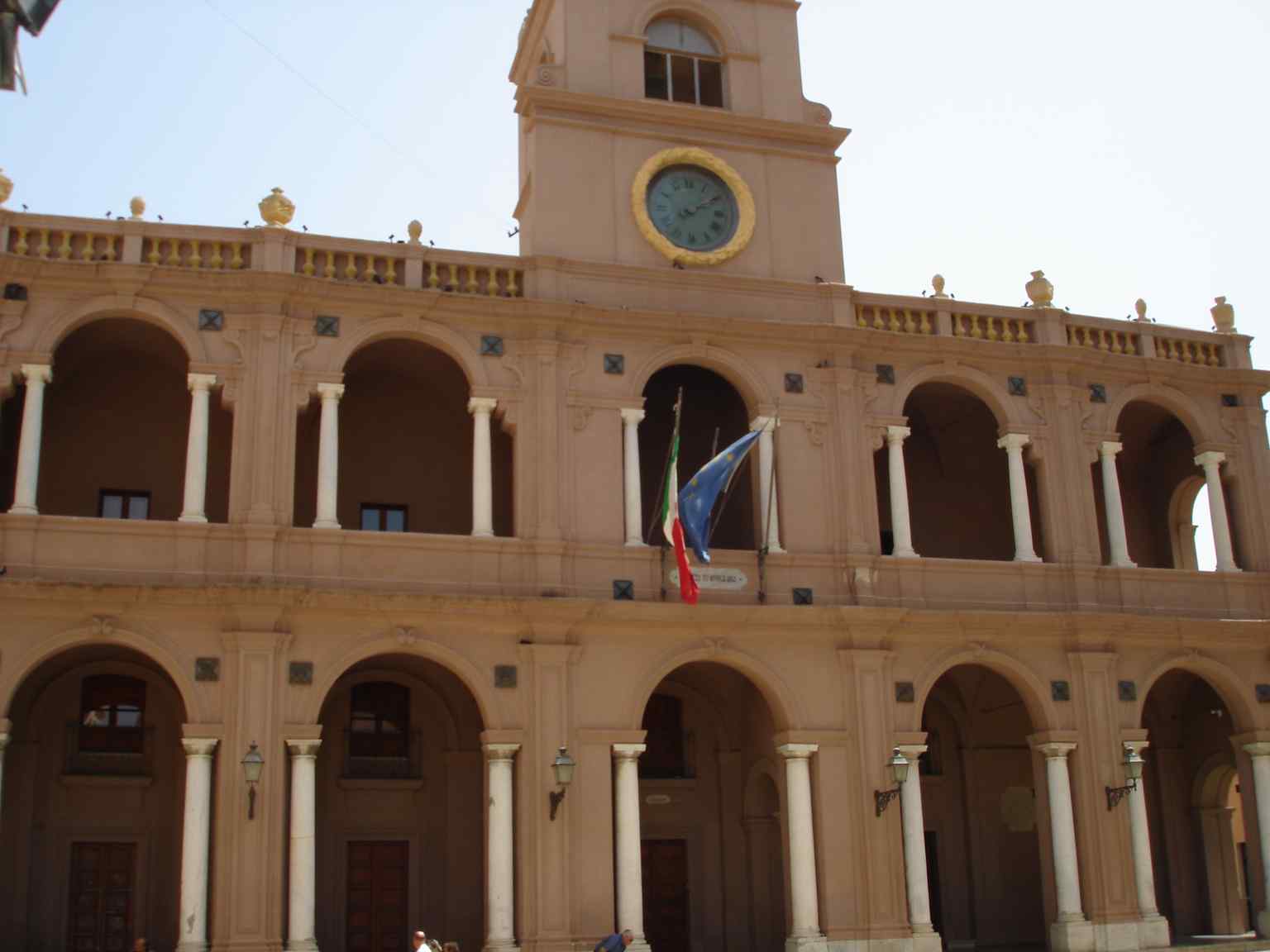 This exterior view of Palazzo VII Aprile showcases its majestic Palladian-style facade and porticos, where Giuseppe Garibaldi's Mille found shelter on the night of May 11, 1860. The clock at the top, originally installed in 1582, still keeps time for Marsala today.