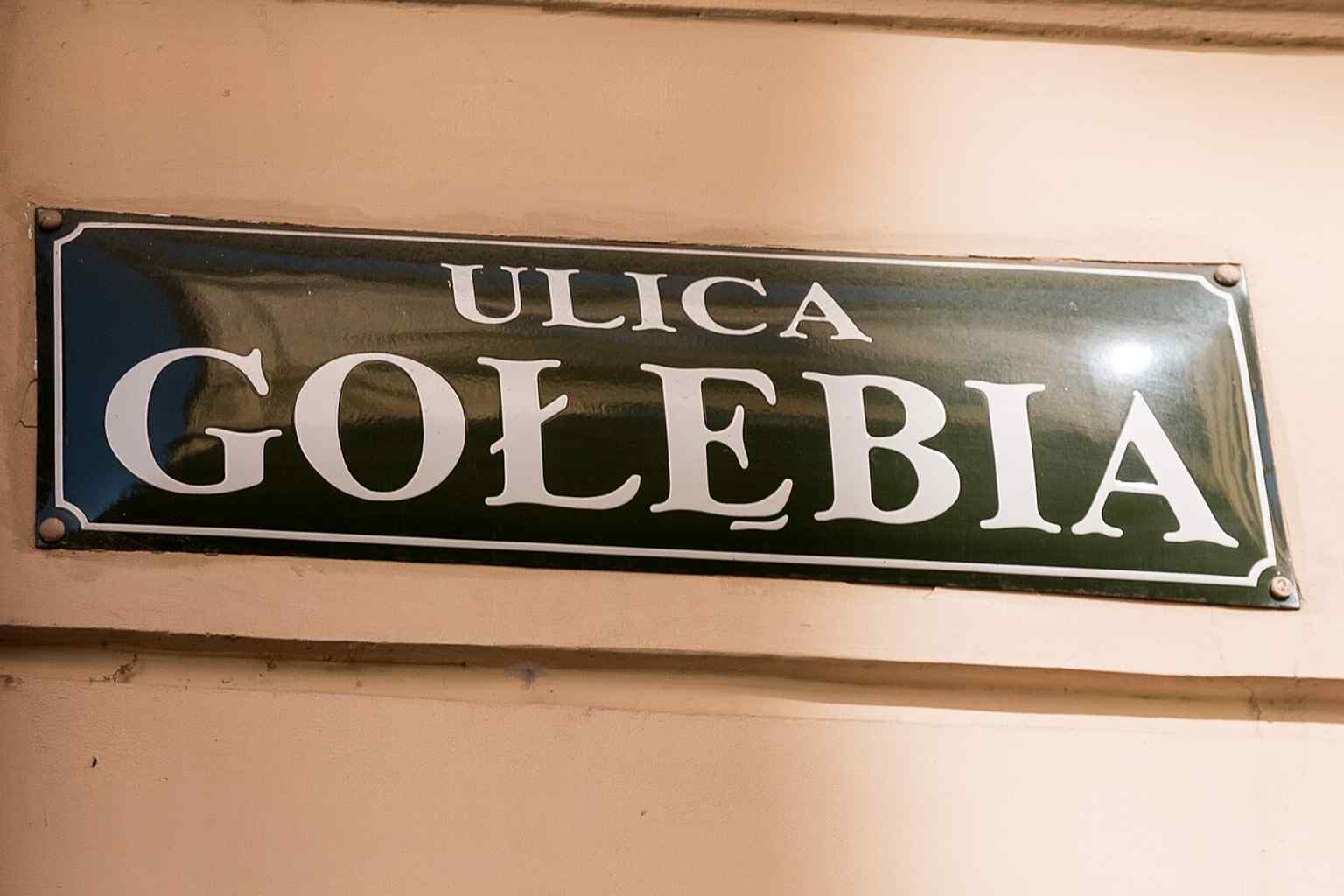 A clear street-level view of Gołębia Street in Kraków’s Old Town, where the Jagiellonian University buildings line the route between Bracka Street and the Planty.