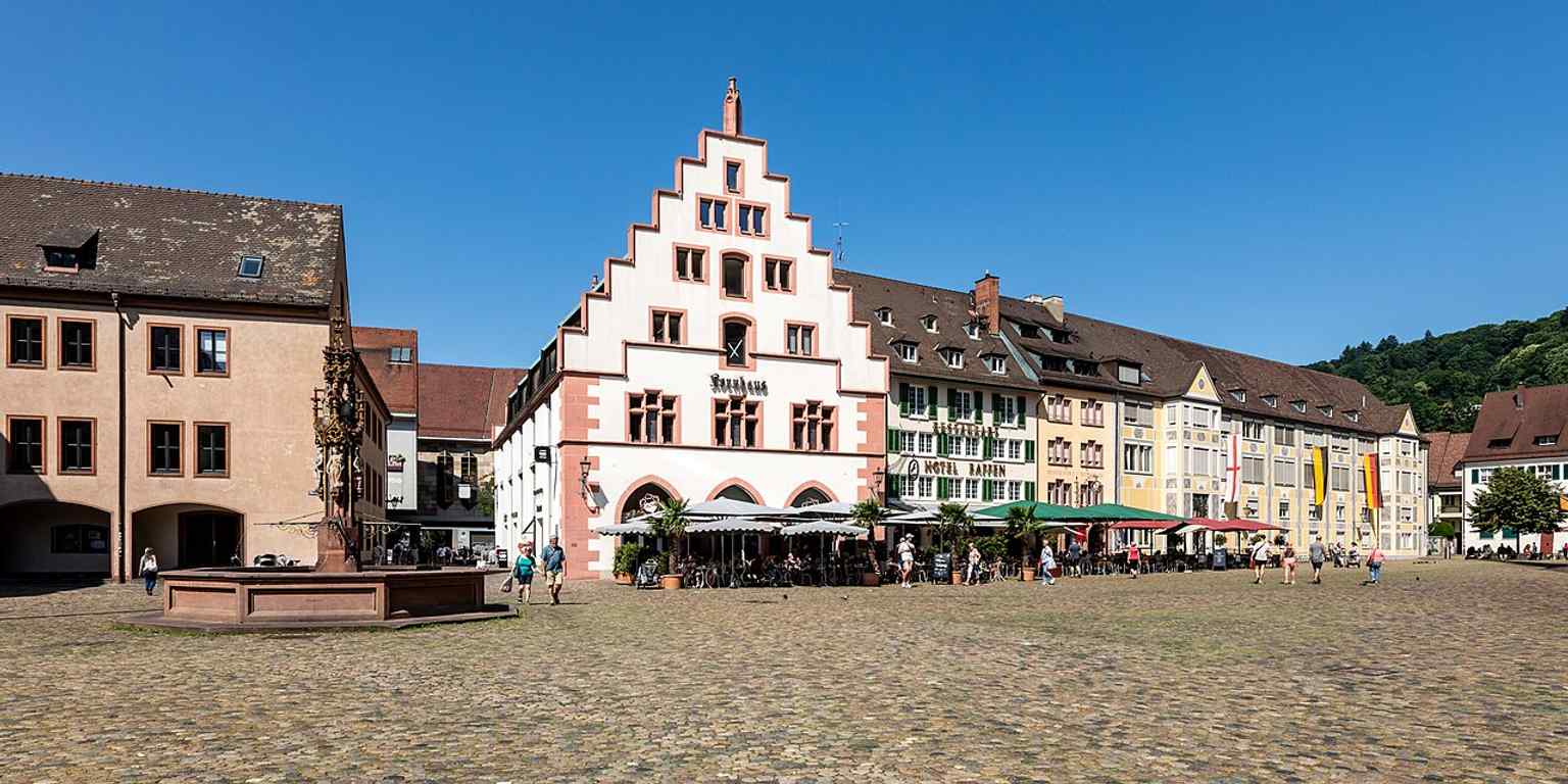 Münsterplatz with the Fischbrunnen and the Kornhaus on the north side, matching the square’s historic market edge and its famous fountain ensemble.