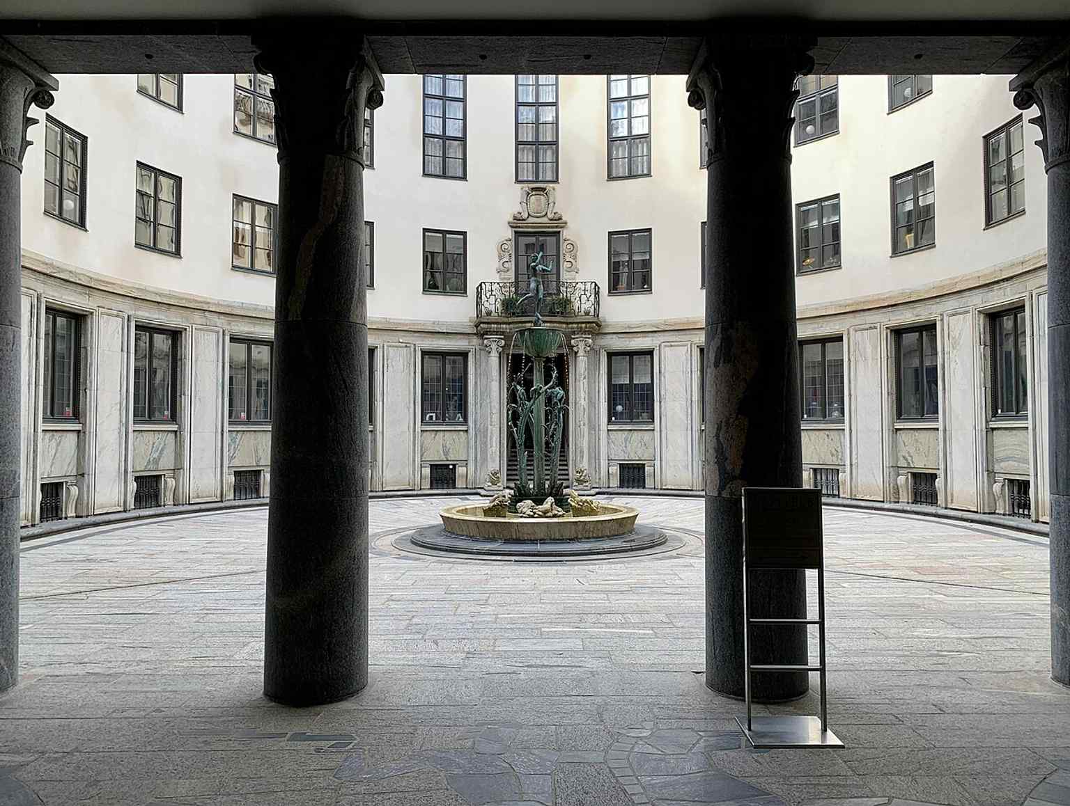 The palace's central horseshoe-shaped courtyard features Carl Milles' 'Diana Fountain' and his bronze sculptures, set within elegant marble slab paving.