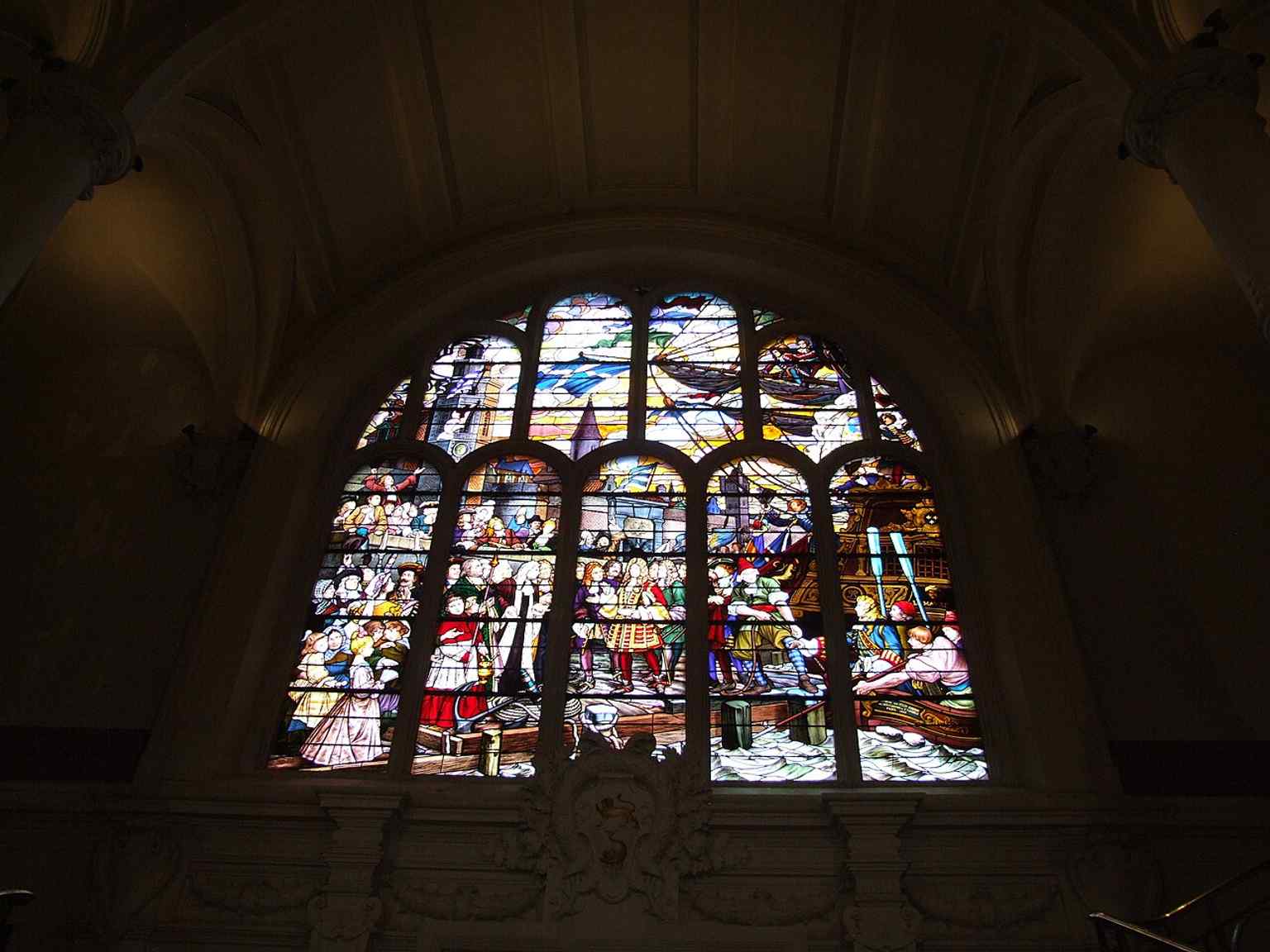 An interior stained-glass window featuring Jean Bart and his crew, echoing the building’s rich decorative tradition.