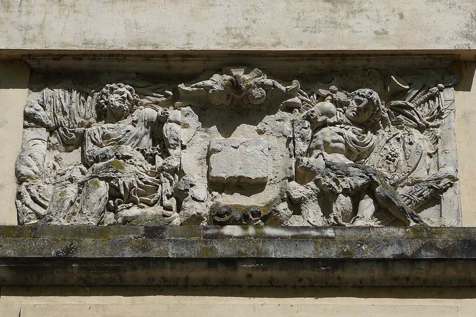 The chained captives bas-relief near Rue de la Boule, a sculpted remnant linked to the quay’s 18th-century monumental entrance.