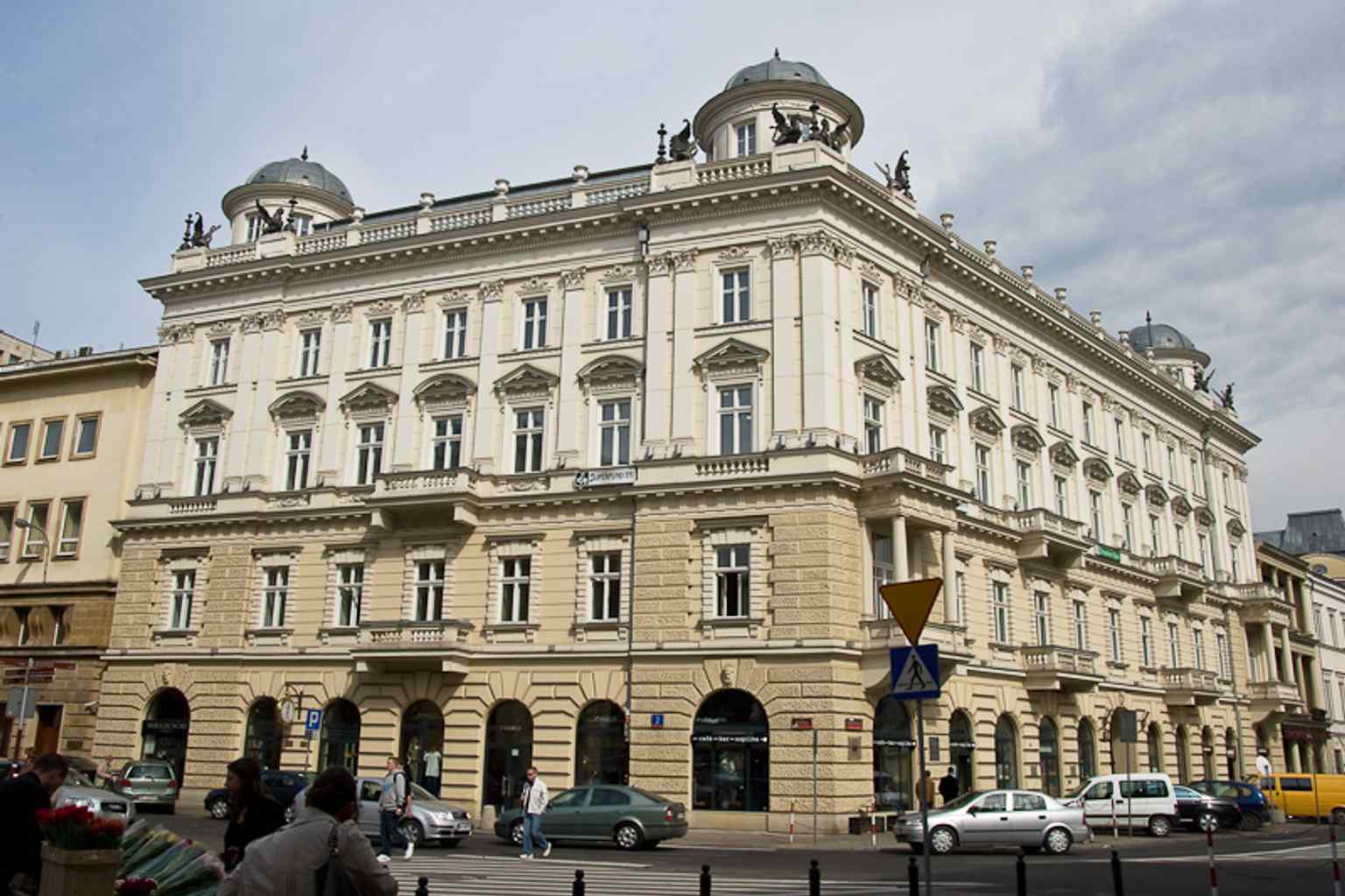 A straight-on façade view that shows the building’s rich Renaissance Revival decoration at Three Crosses Square.