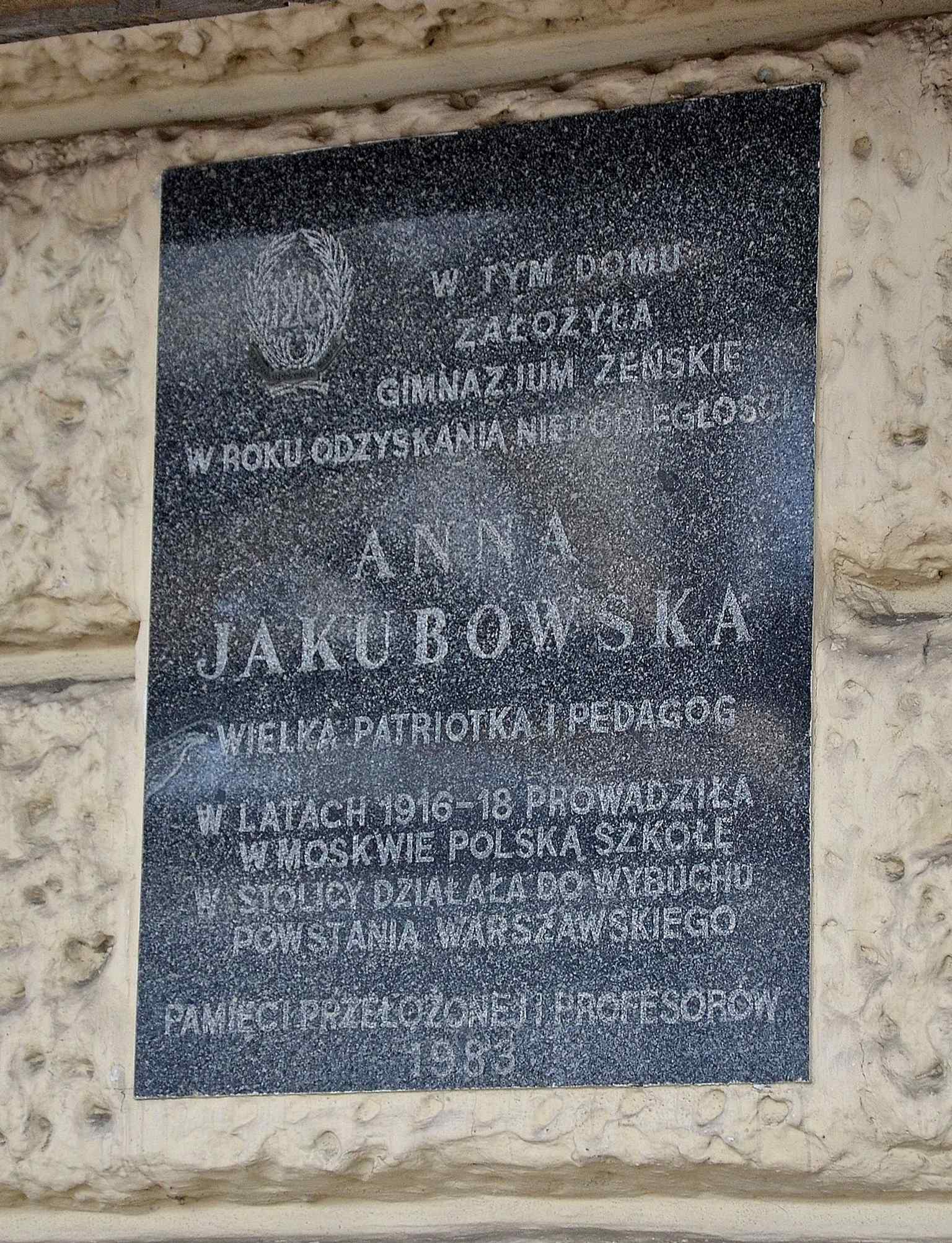 The Anna Jakubowska commemorative plaque on the façade, marking the school director remembered here since 1983.
