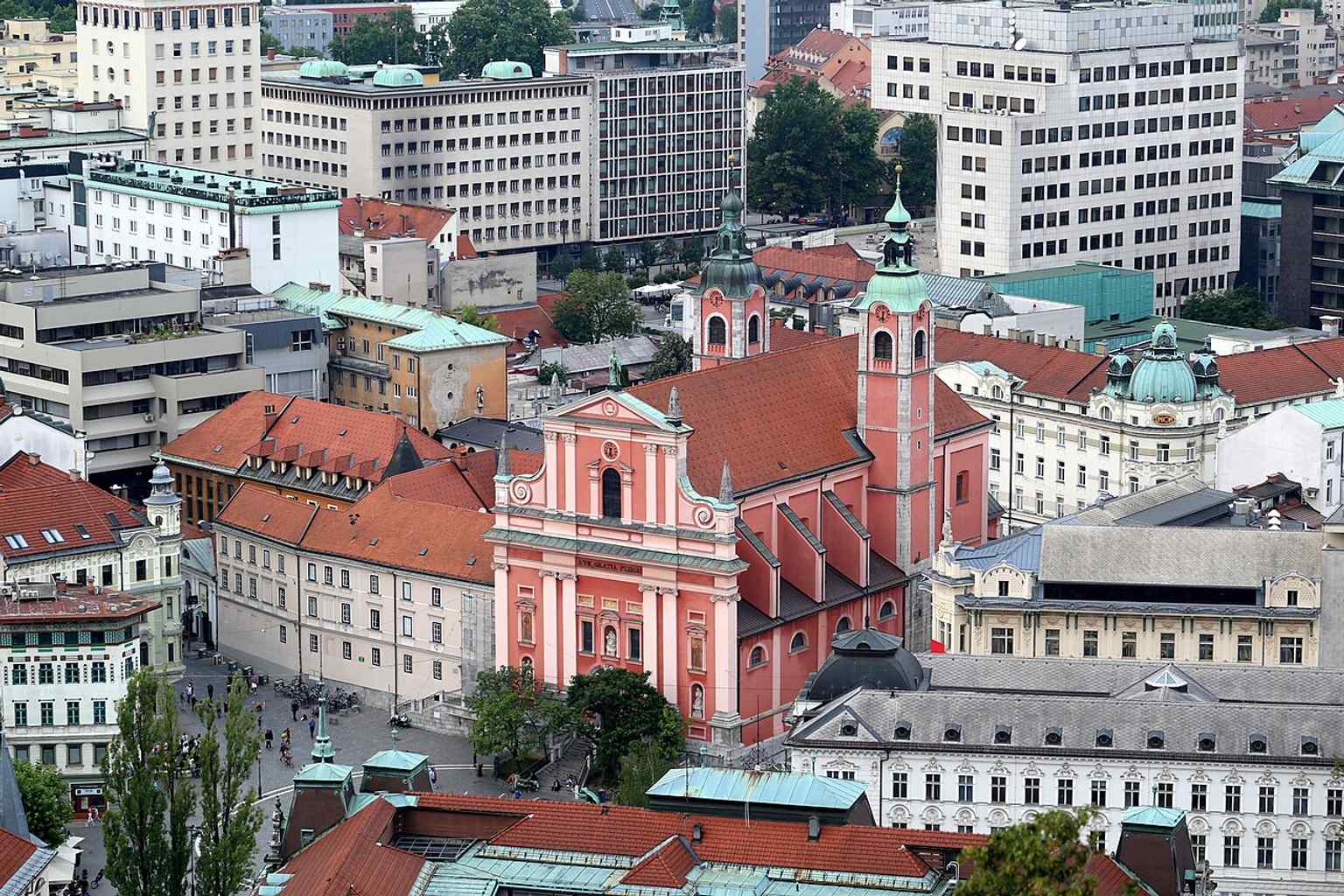 The Church of the Annunciation on Prešeren Square, known for its distinctive salmon-pink color, a shade adopted after the Franciscans took over in the church in the 18th century.