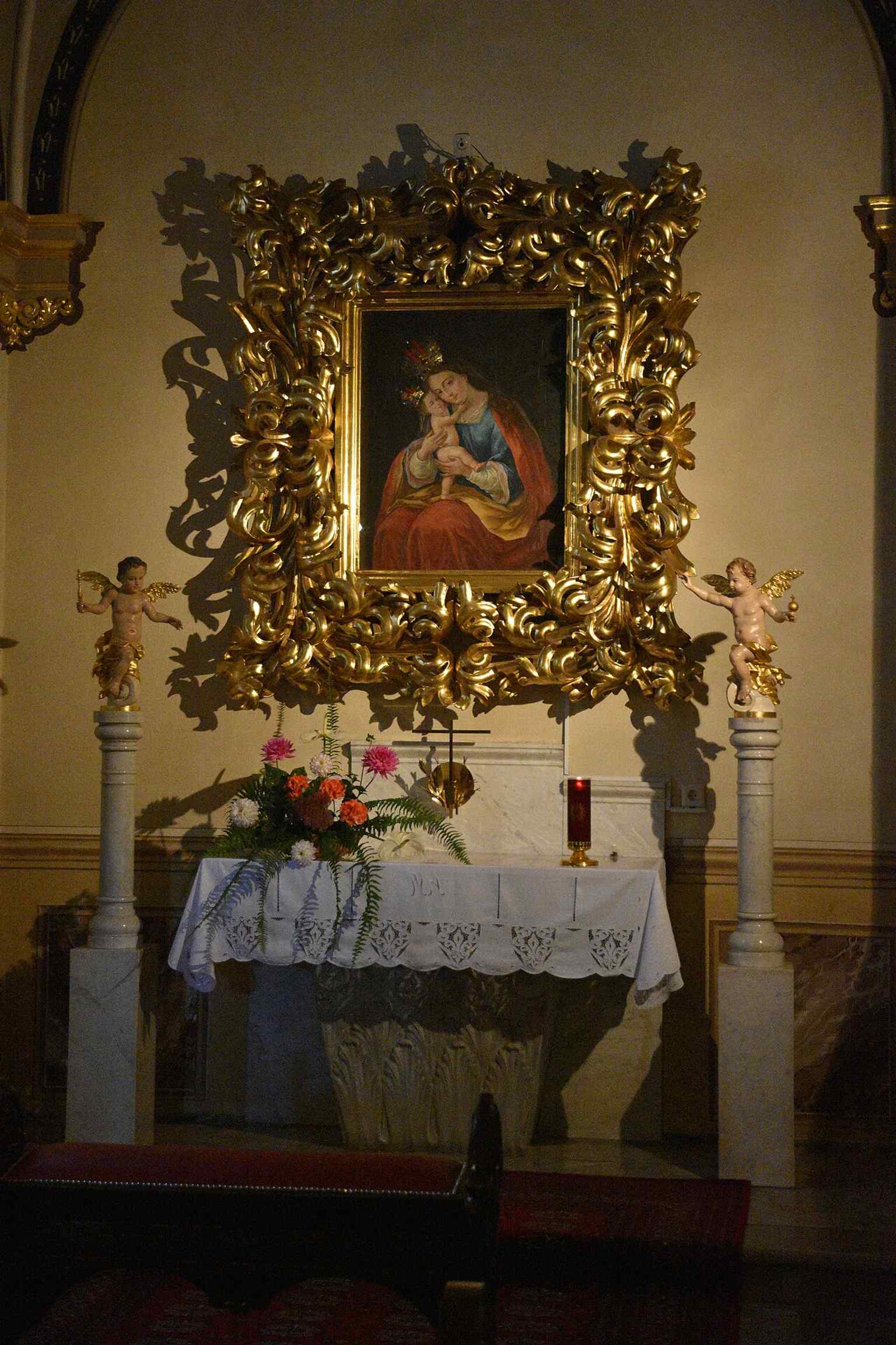 The monumental Baroque main altar, a masterpiece created by Venetian sculptor Francesco Robba, though he died before its full completion in 1757.
