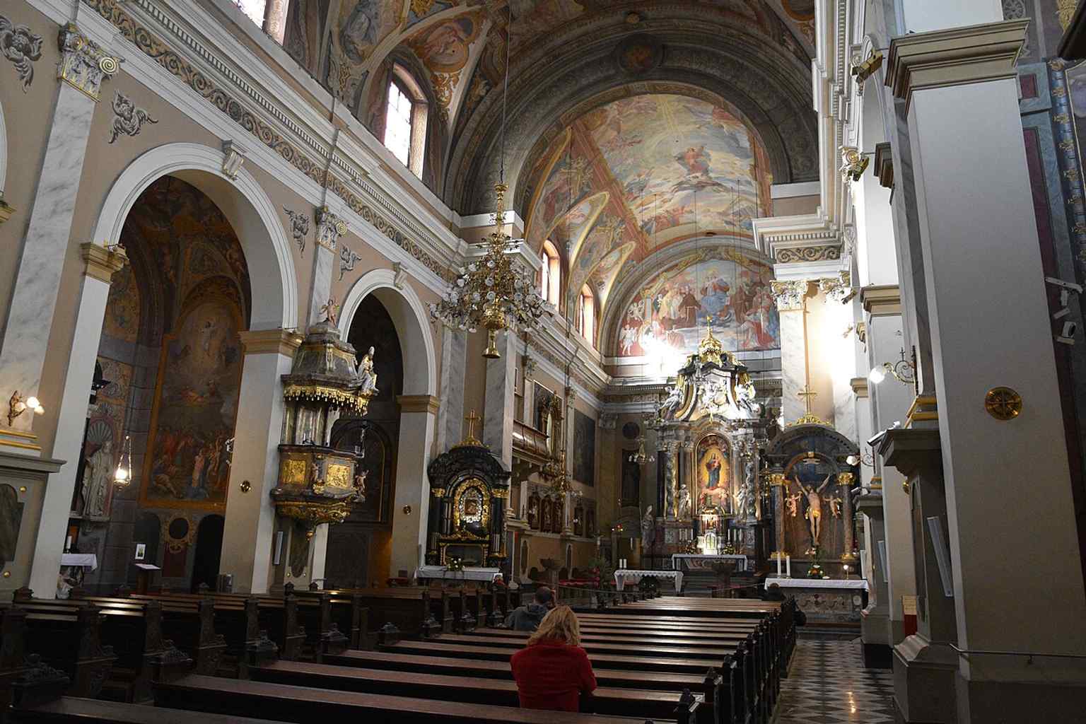 The vibrant ceiling frescoes, painted in the 1930s by Matej Sternen in an illusionistic Baroque style after the originals were destroyed in the 1895 earthquake.