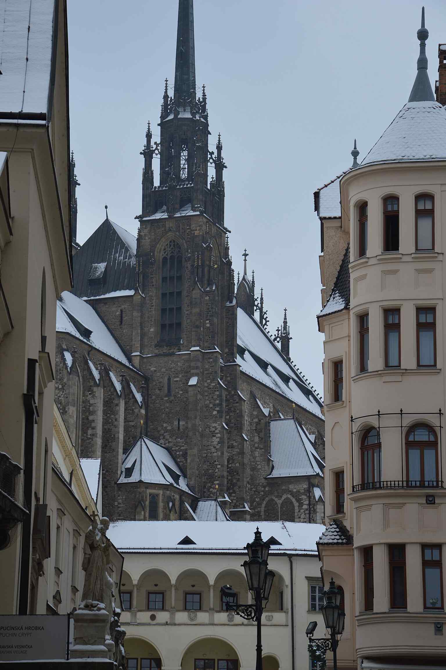 A clean modern view of the twin-towered cathedral, the Brno landmark that rises 84 meters above Petrov hill.