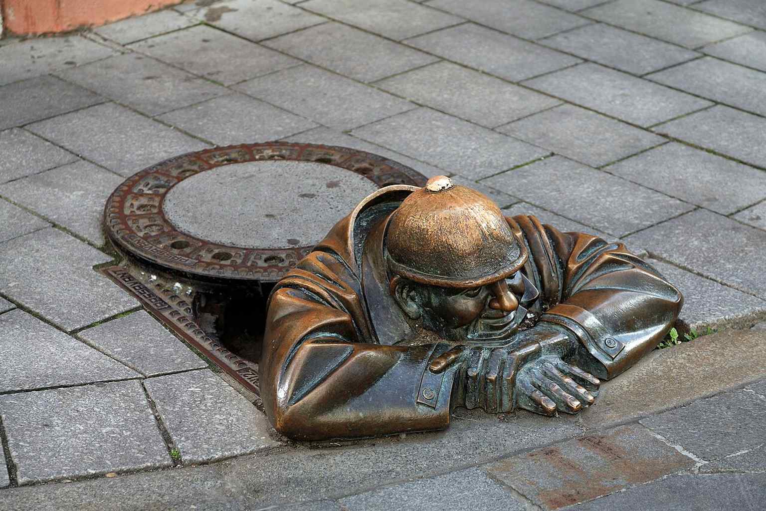 Another strong close-up of Čumil from the corner of Panská and Rybárska brána, emphasizing the statue’s hidden, joking character.