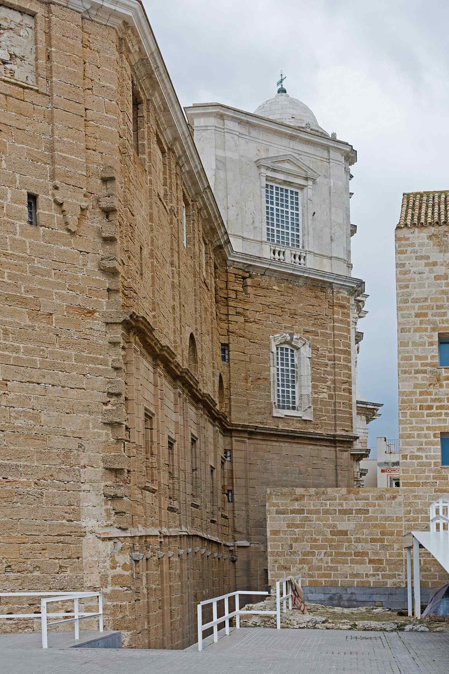 A street-level view from Avenida Campo del Sur, showing how visible the cathedral is from across the historic seafront.