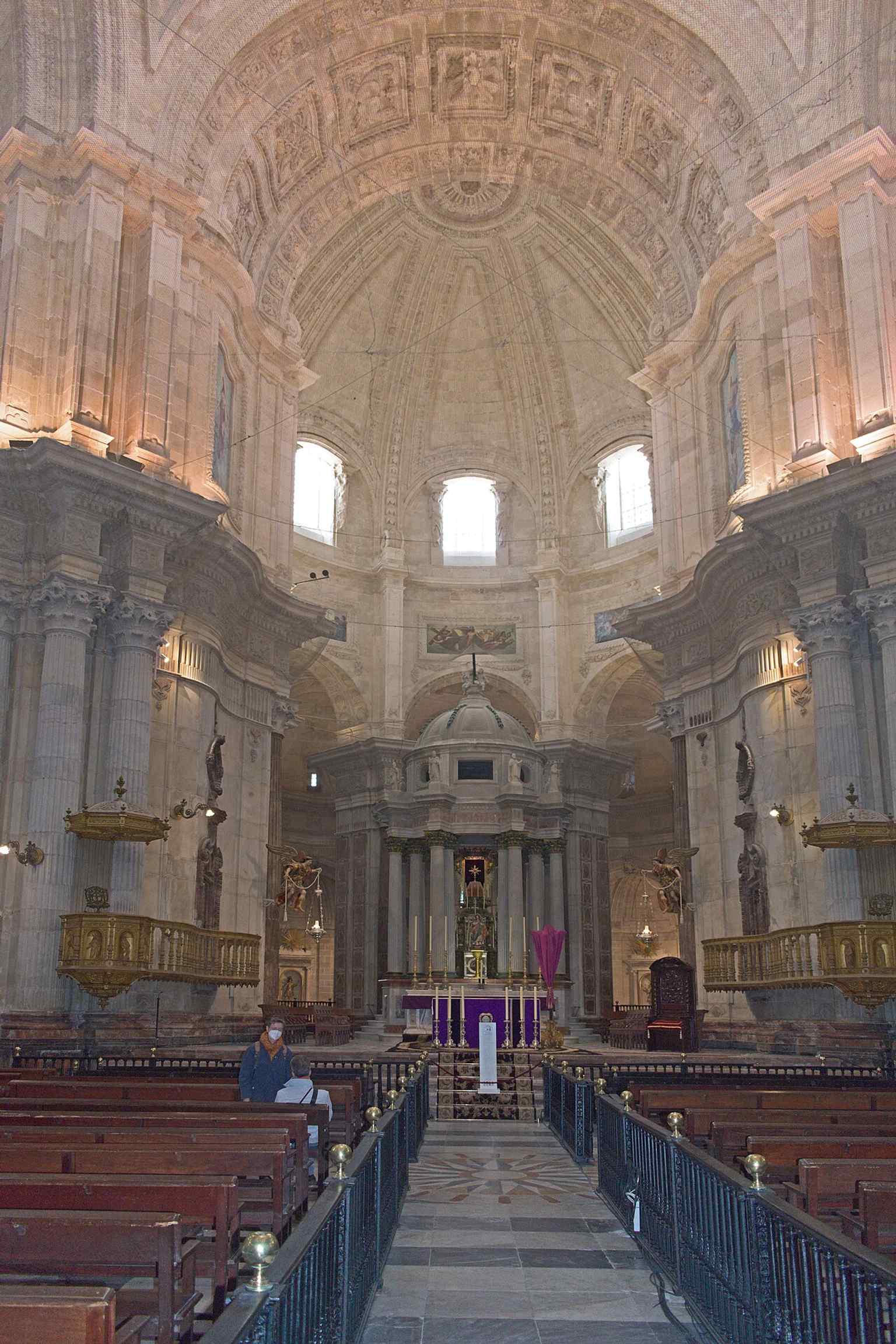 The apse interior, showing the temple’s neoclassical order and the scale of the space behind the altar.