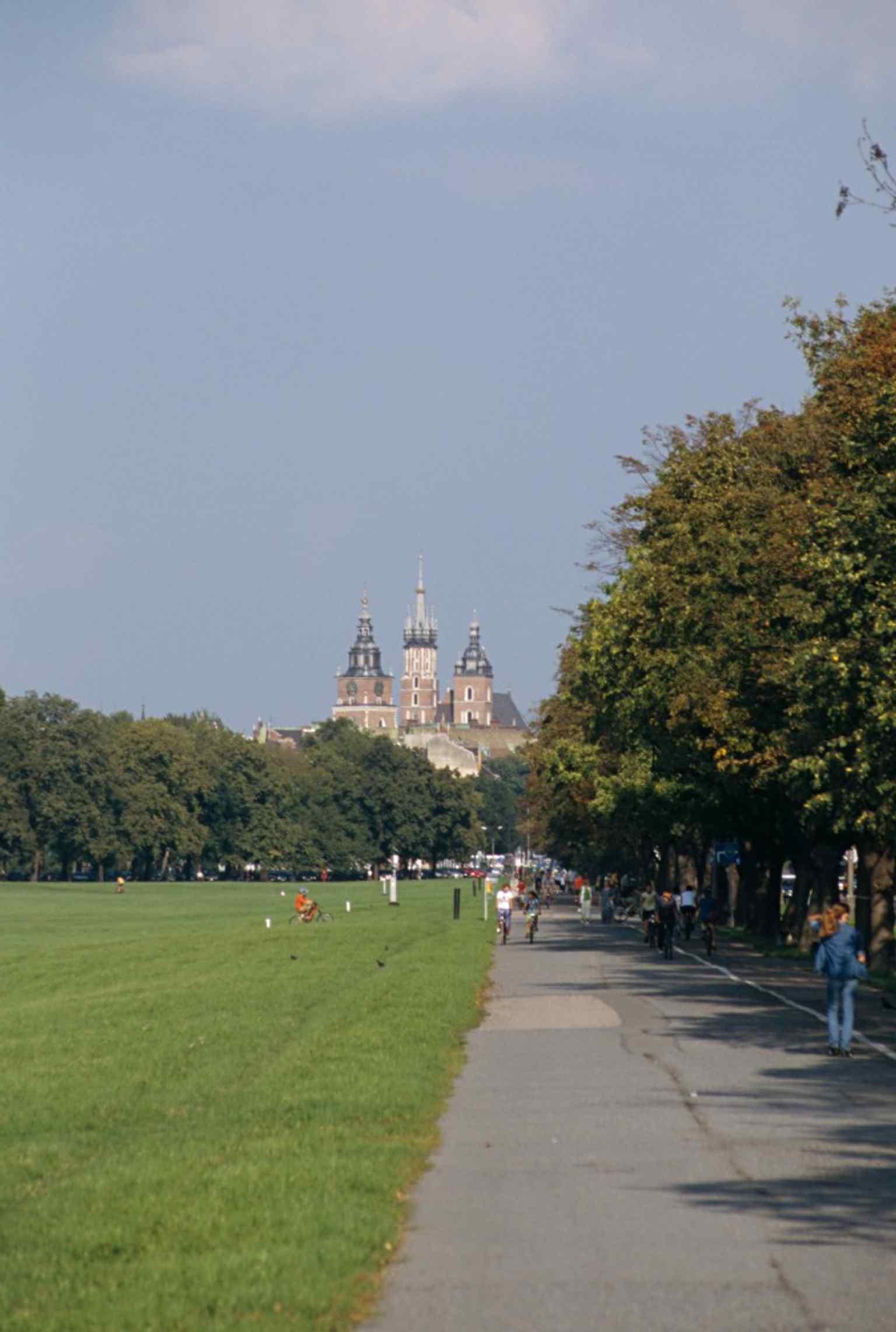 A broad view across the square with the tower and St. Mary’s towers in the distance, capturing the tower’s place in Kraków’s urban panorama.