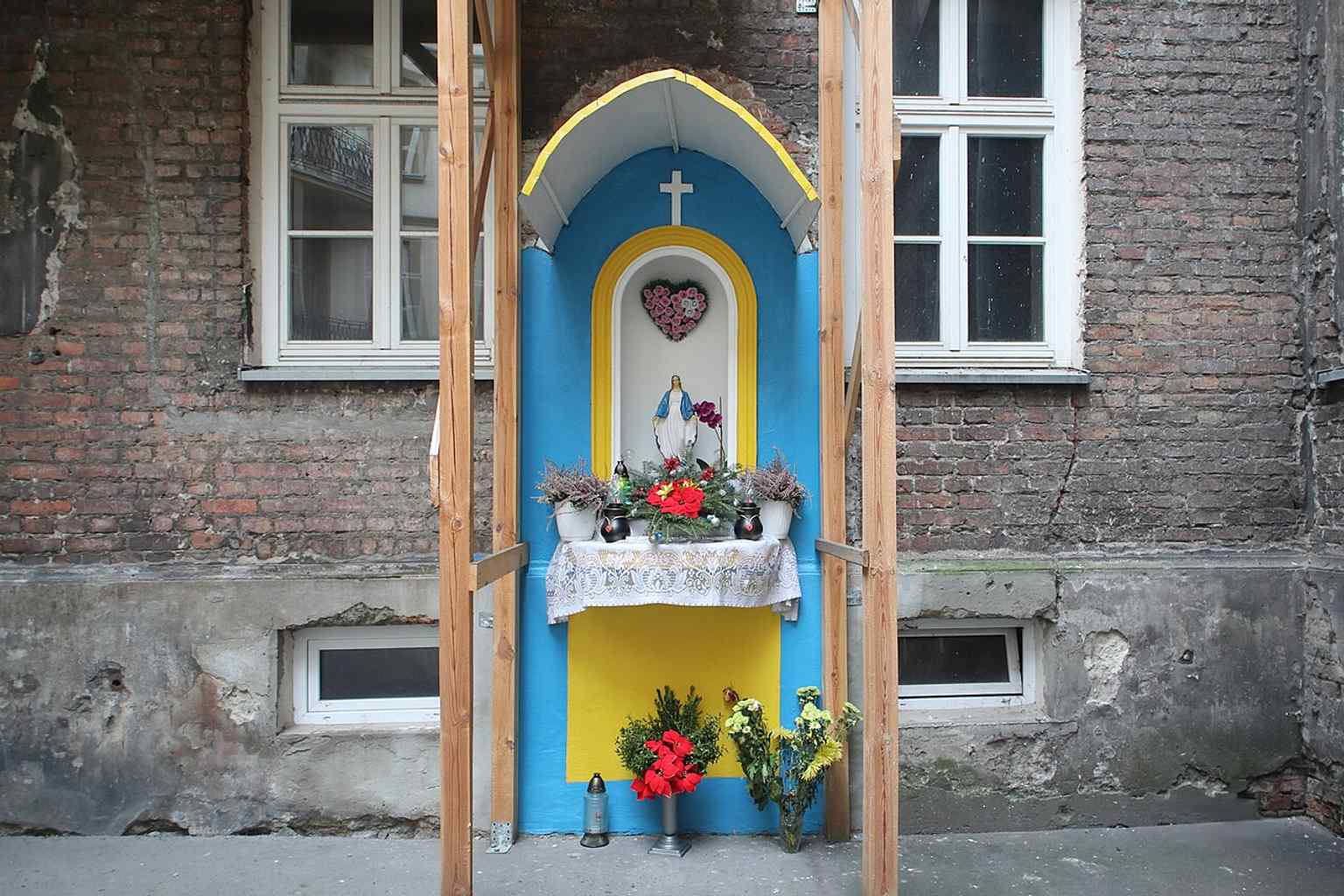 A Marian shrine in the courtyard of Mokotowska 65, showing the quiet everyday traditions that persist behind the façades.