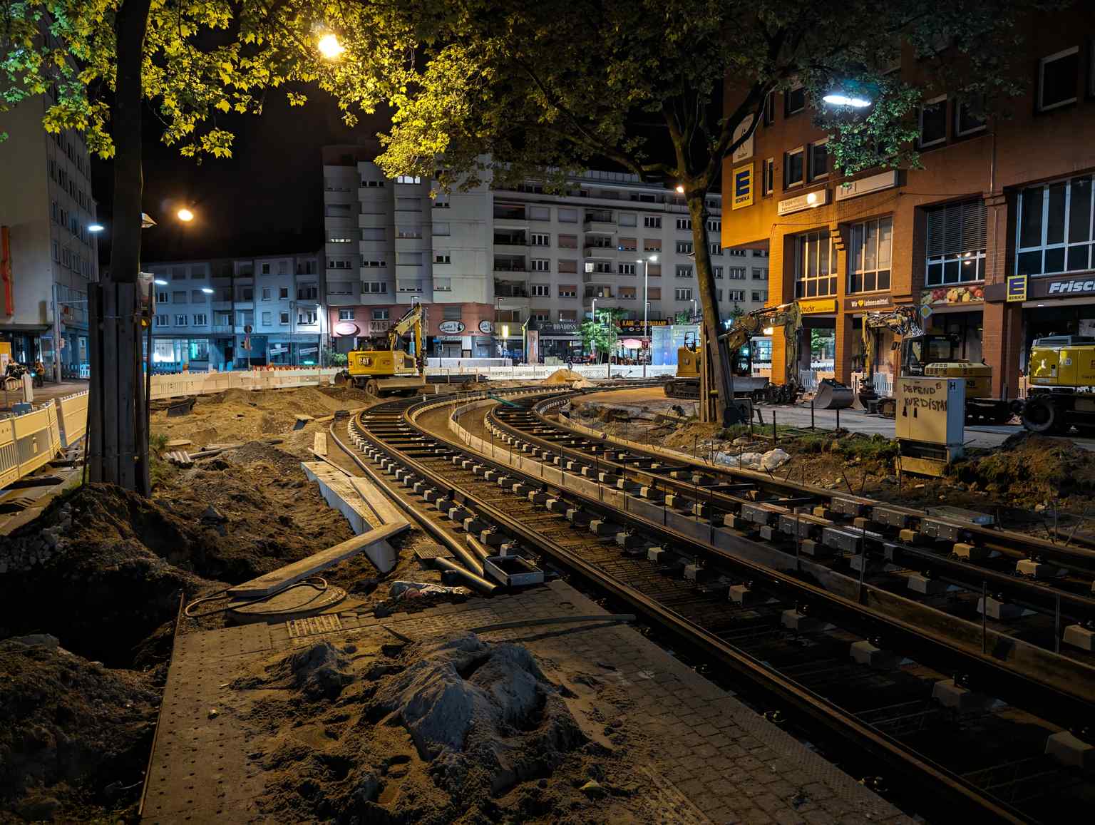 View of the tram tracks at Kronenplatz during night-time construction, located near the Straßenbahnhaltestelle in Fritz-Erler-Straße.