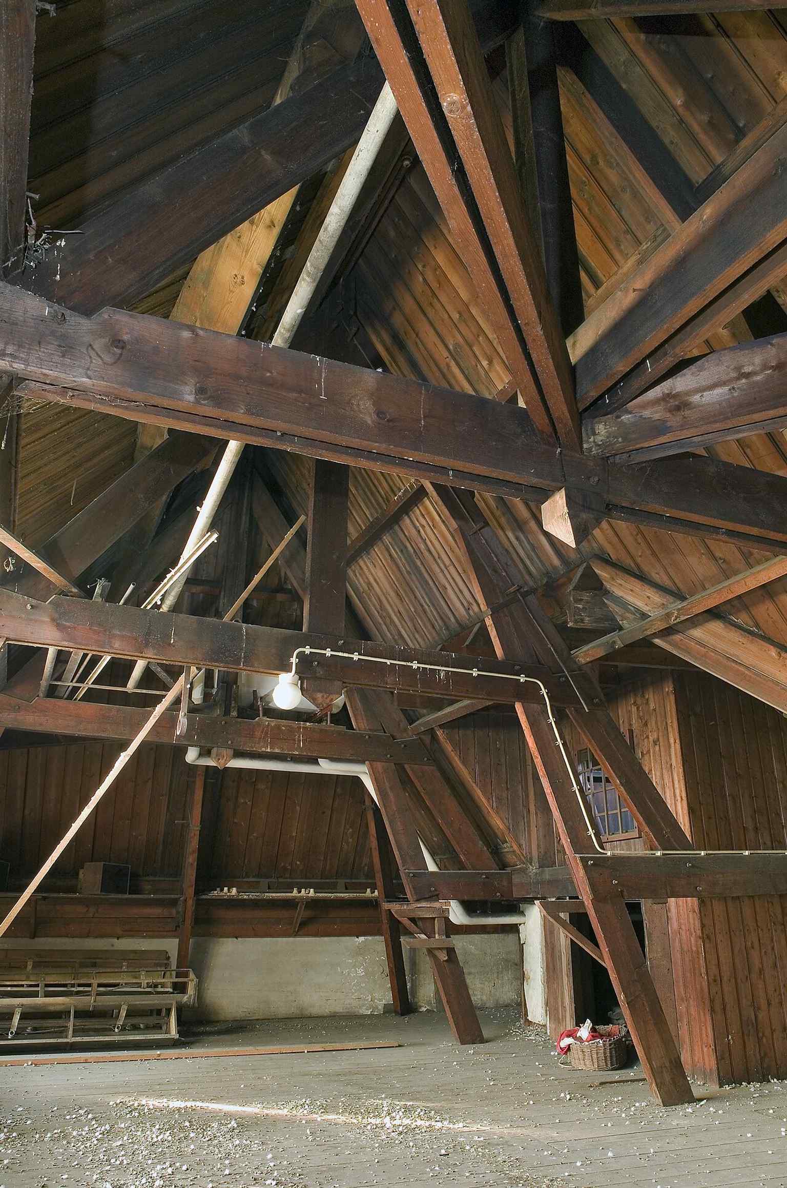 The roof structure reveals the building’s historic bones behind the modern pop-podium operation.