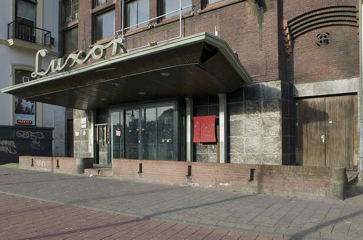 The canopy above the entrance highlights the building’s grand movie-theater appearance from its early days.